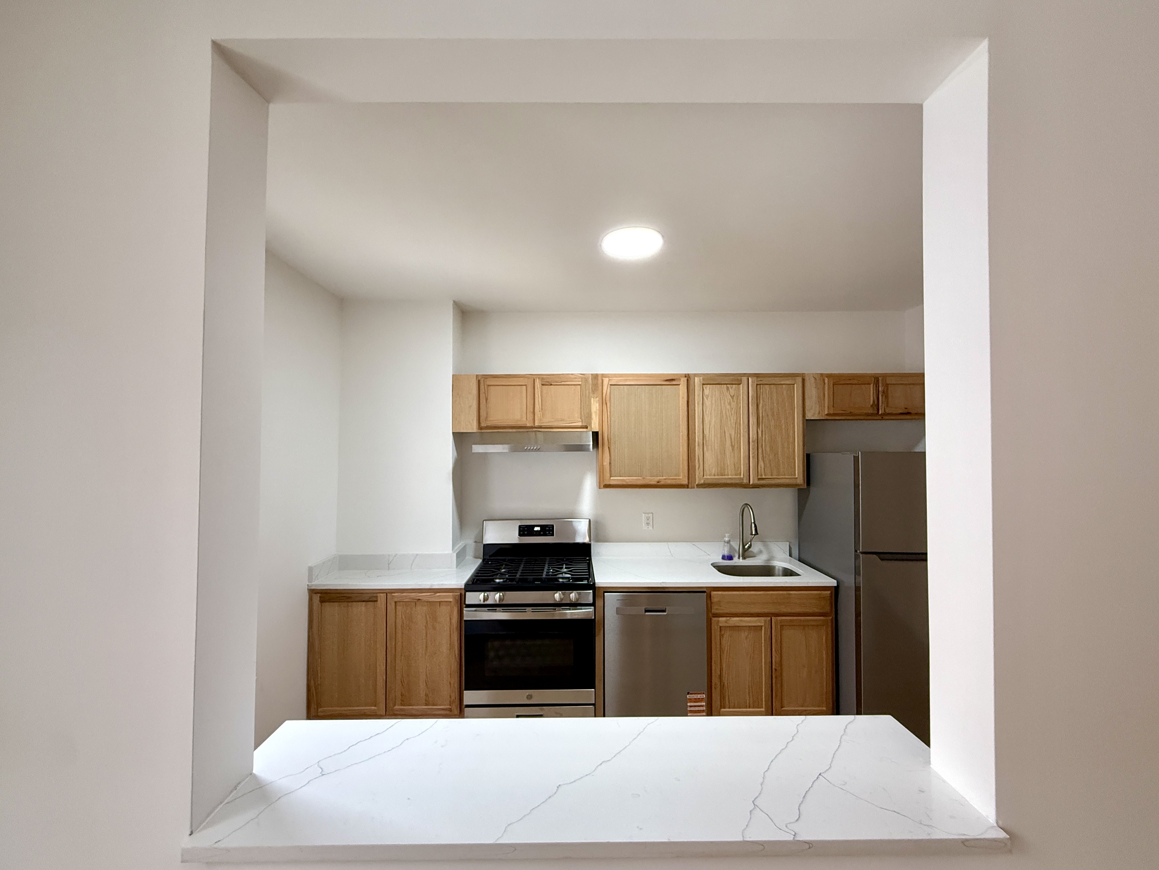 31 Seeley Street, Unit Undisclosed Brooklyn, NY 11218 - Photo 8 of 31 a kitchen with stainless steel appliances a sink stove and refrigerator