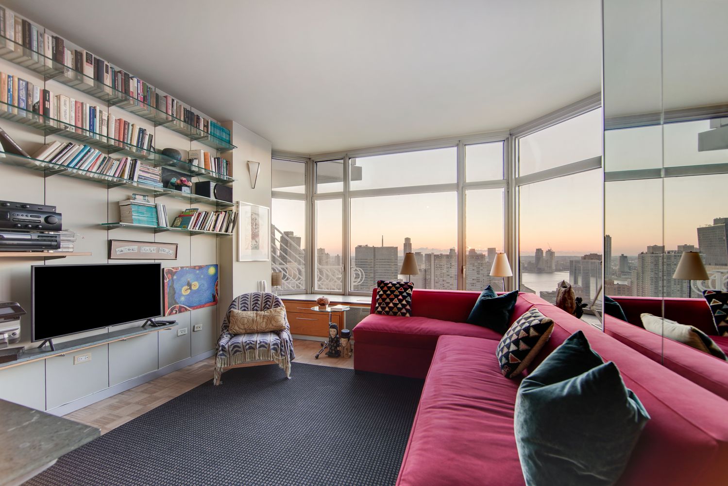 a living room with furniture tv and a large window