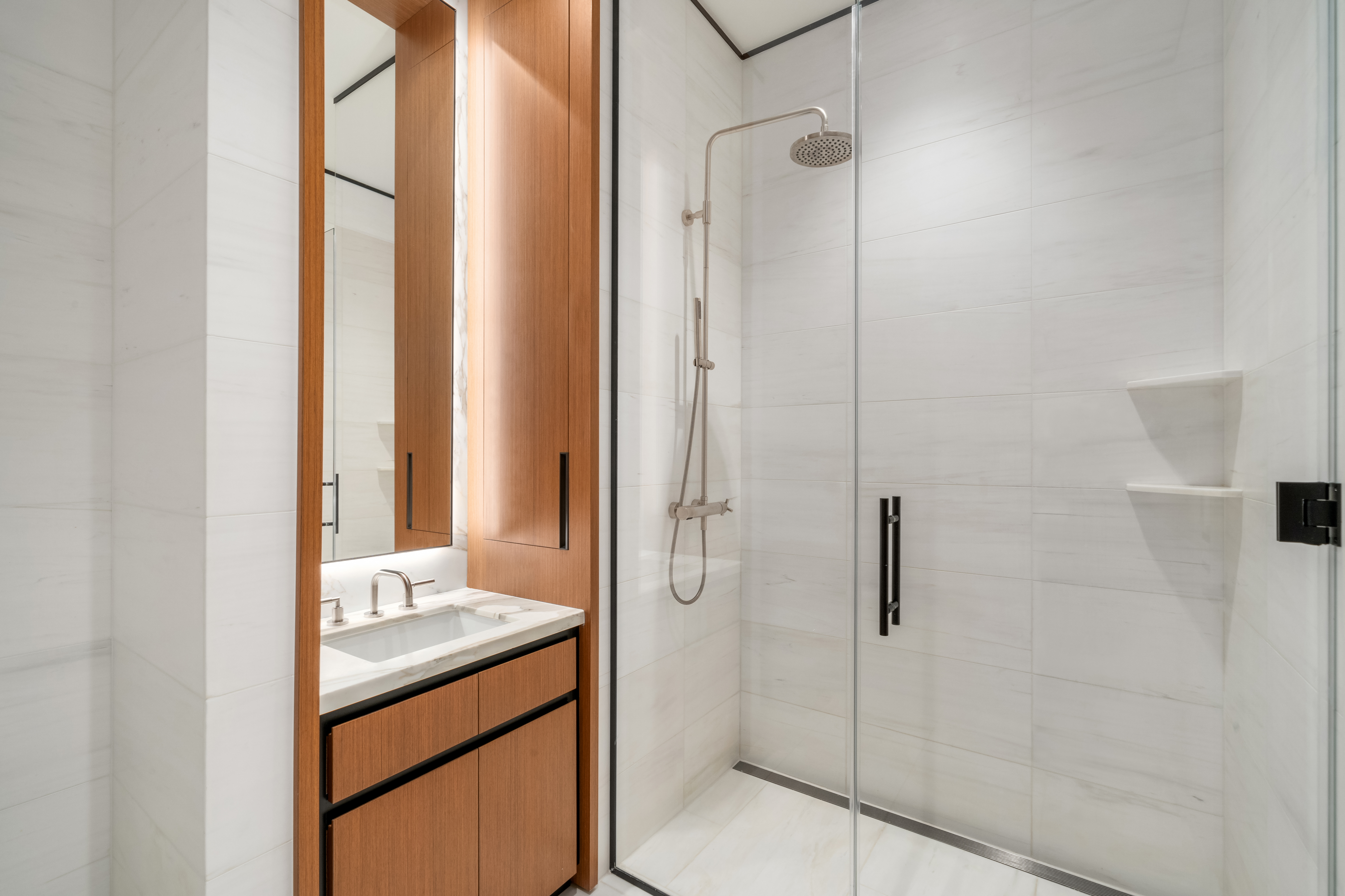 15 East 30th Street, Unit 42A Manhattan, NY 10016 - Photo 8 of 13 a bathroom with a granite countertop sink mirror and shower