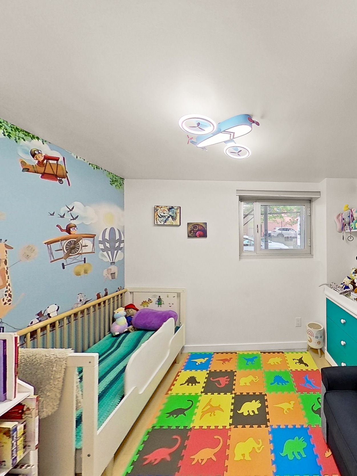 560 Carroll Street, Unit 1D Brooklyn, NY 11215 - Photo 8 of 19 a bedroom with baby bed toys and paintings on the wall