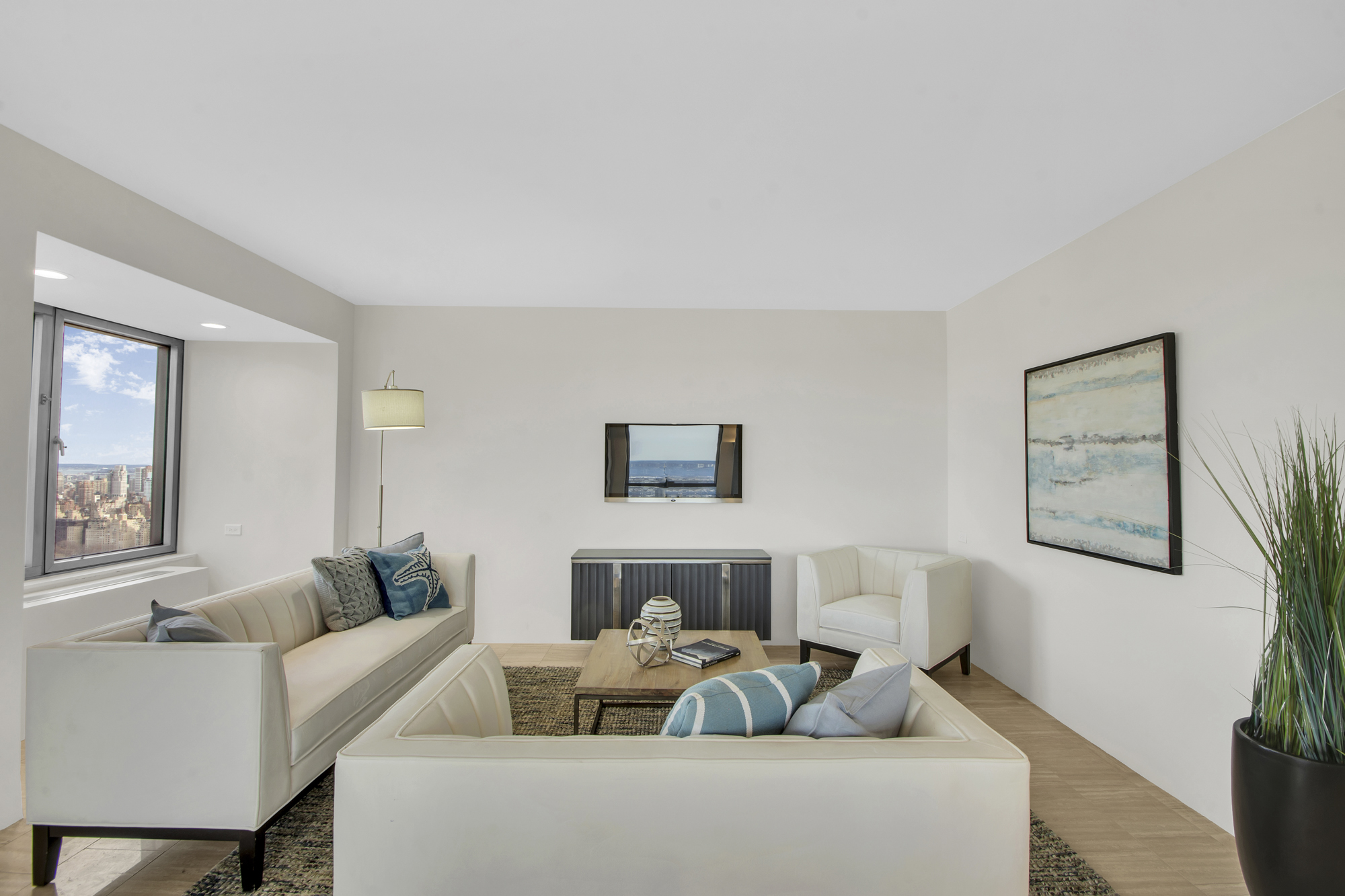 301 West 57th Street, Unit 48A Manhattan, NY 10019 - Photo 4 of 22 a living room with furniture and a couch