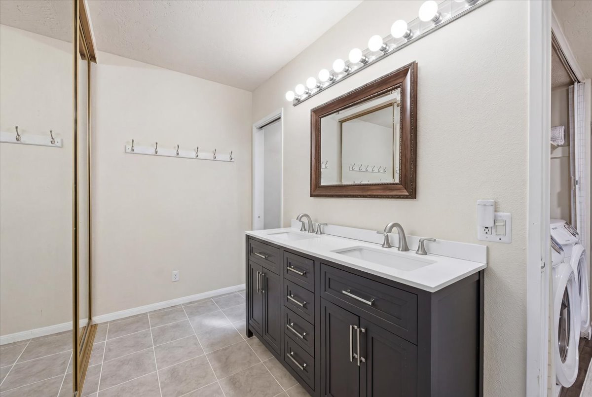 6373 Rancho Mission Road, Unit 5 San Diego, CA 92108 - Photo 16 of 30 a bathroom with a double vanity sink and a mirror