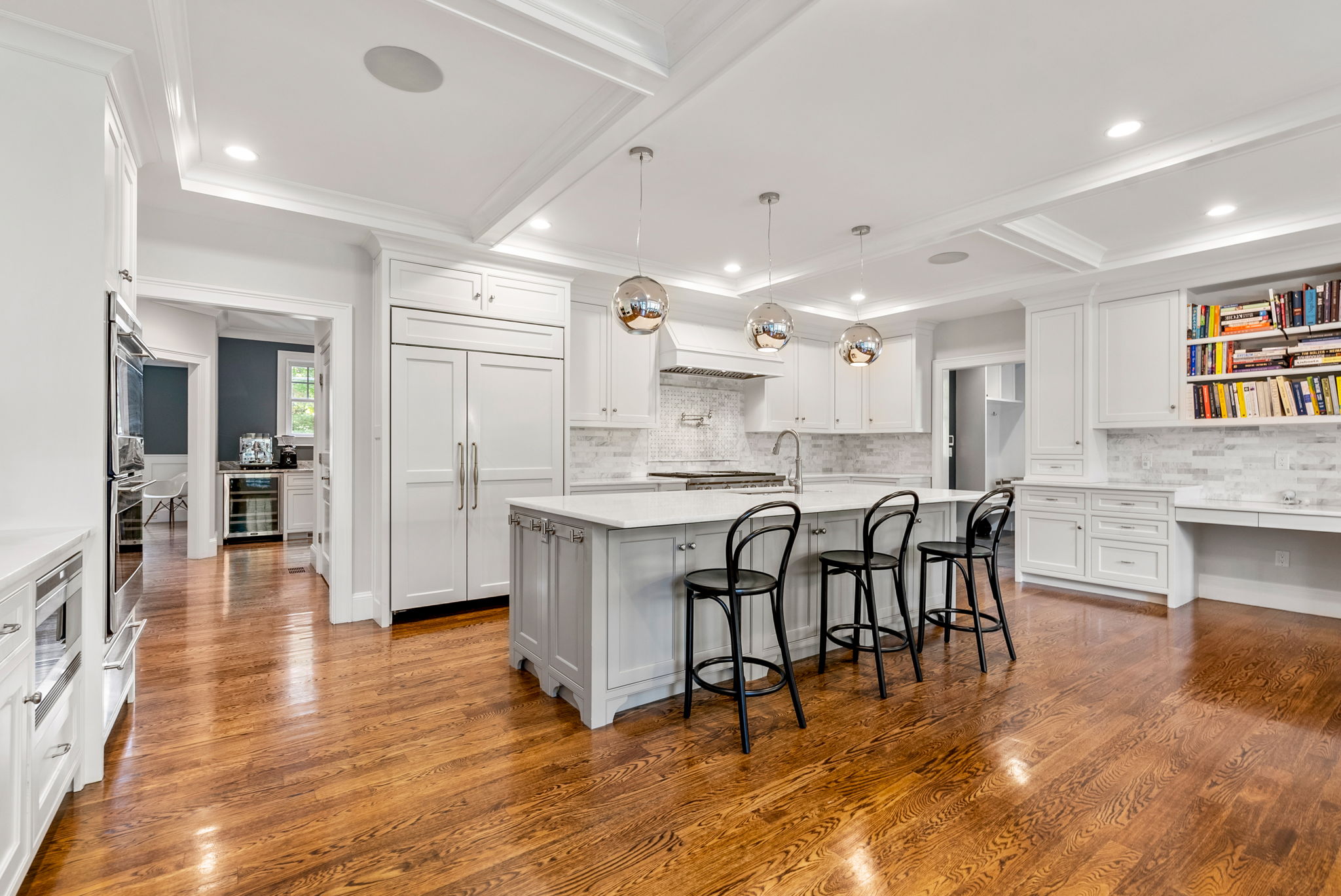 9 Wynnewood Road Wellesley Hills, MA 02481 - Photo 5 of 27 a kitchen with stainless steel appliances kitchen island granite countertop a table chairs sink and cabinets