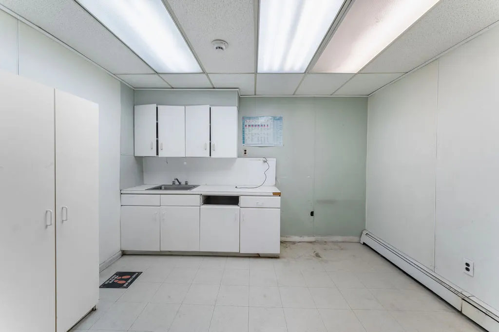 a view of room with wooden floor and cabinet