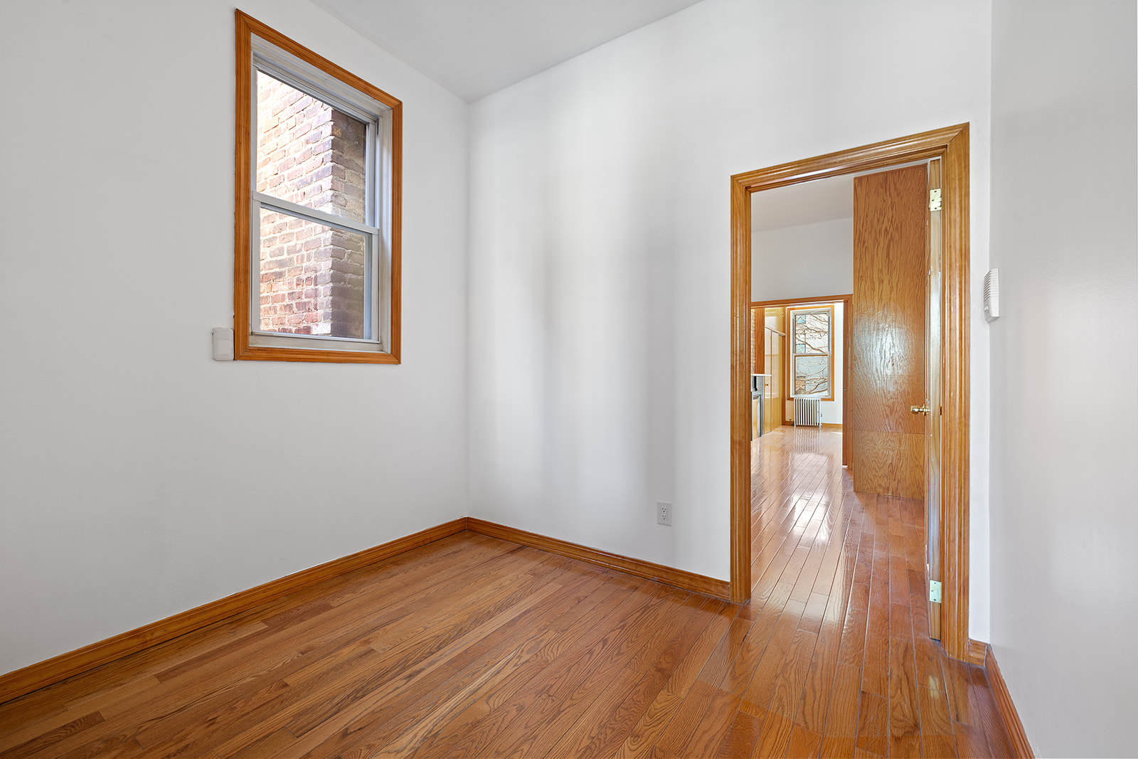 83 Maujer Street, Unit 2R Brooklyn, NY 11206 - Photo 3 of 6 a view of empty room with wooden floor and fan
