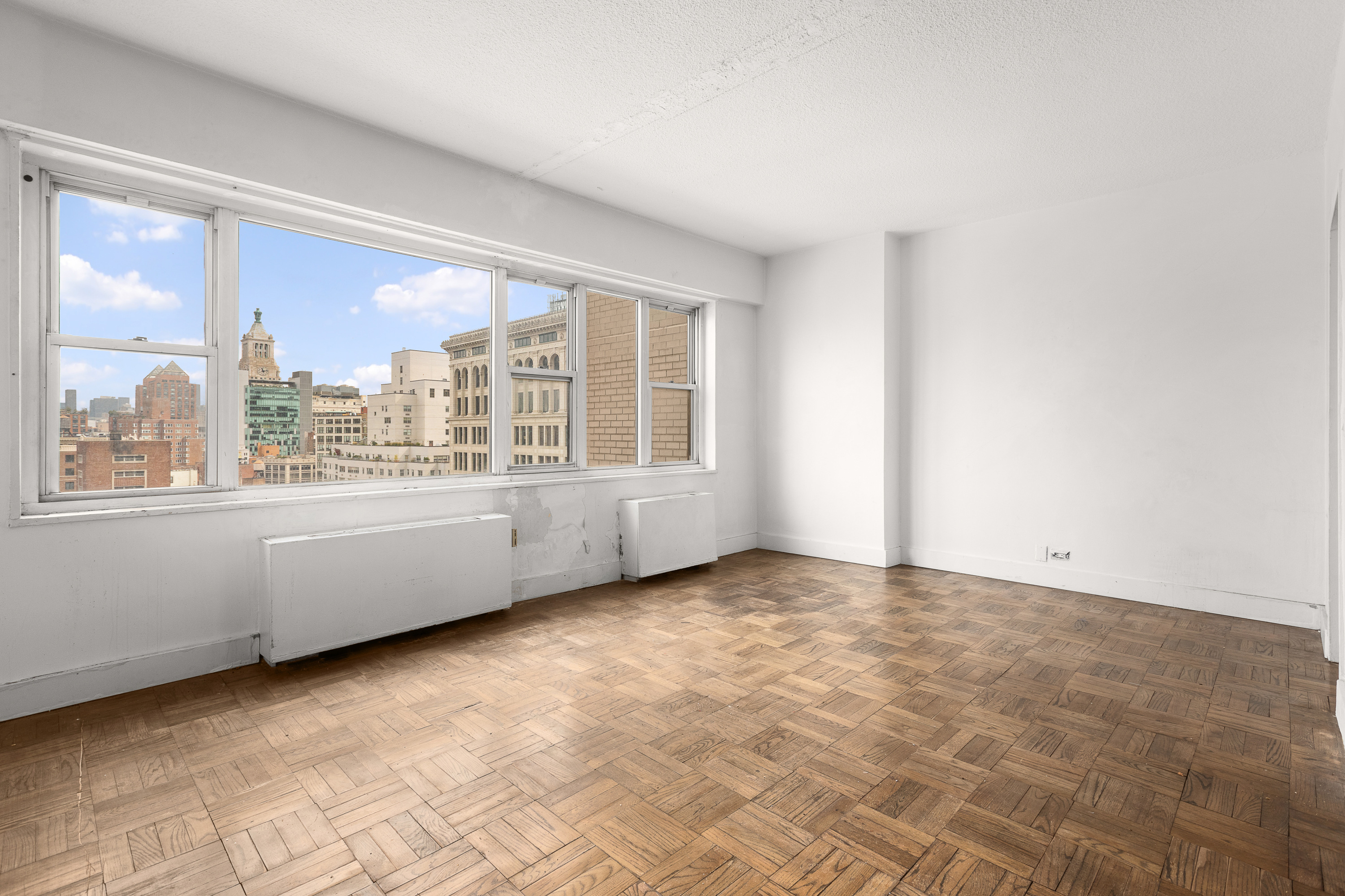 60 East 8th Street, Unit 18J Manhattan, NY 10003 - Photo 4 of 10 a view of an empty room with a window