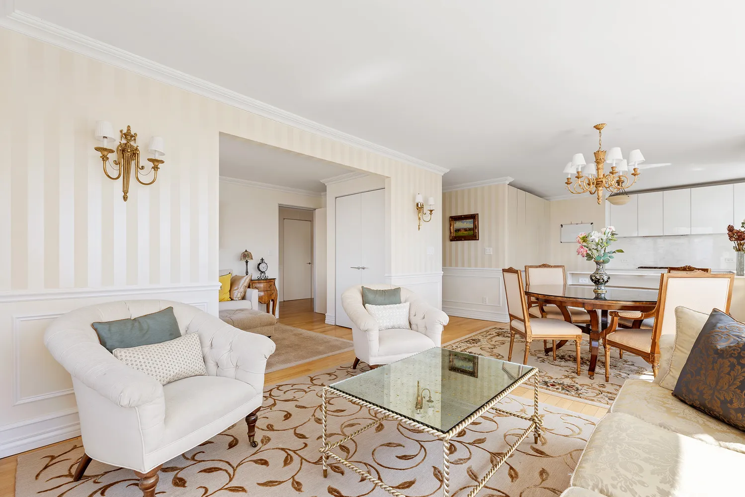 a living room with furniture and a chandelier