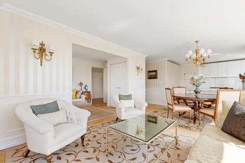 a living room with furniture and a chandelier