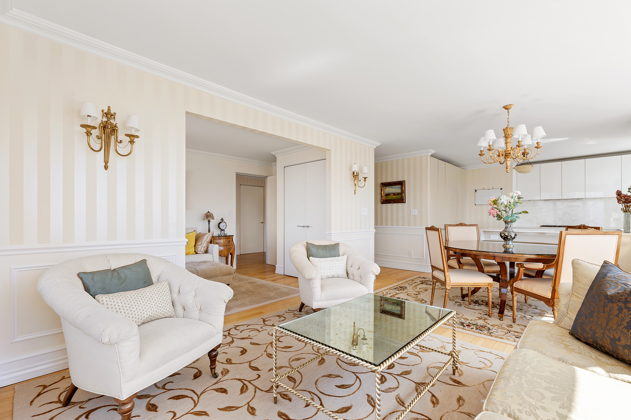 322 West 57th Street, Unit 33U Manhattan, NY 10019 - Photo 3 of 18 a living room with furniture and a chandelier