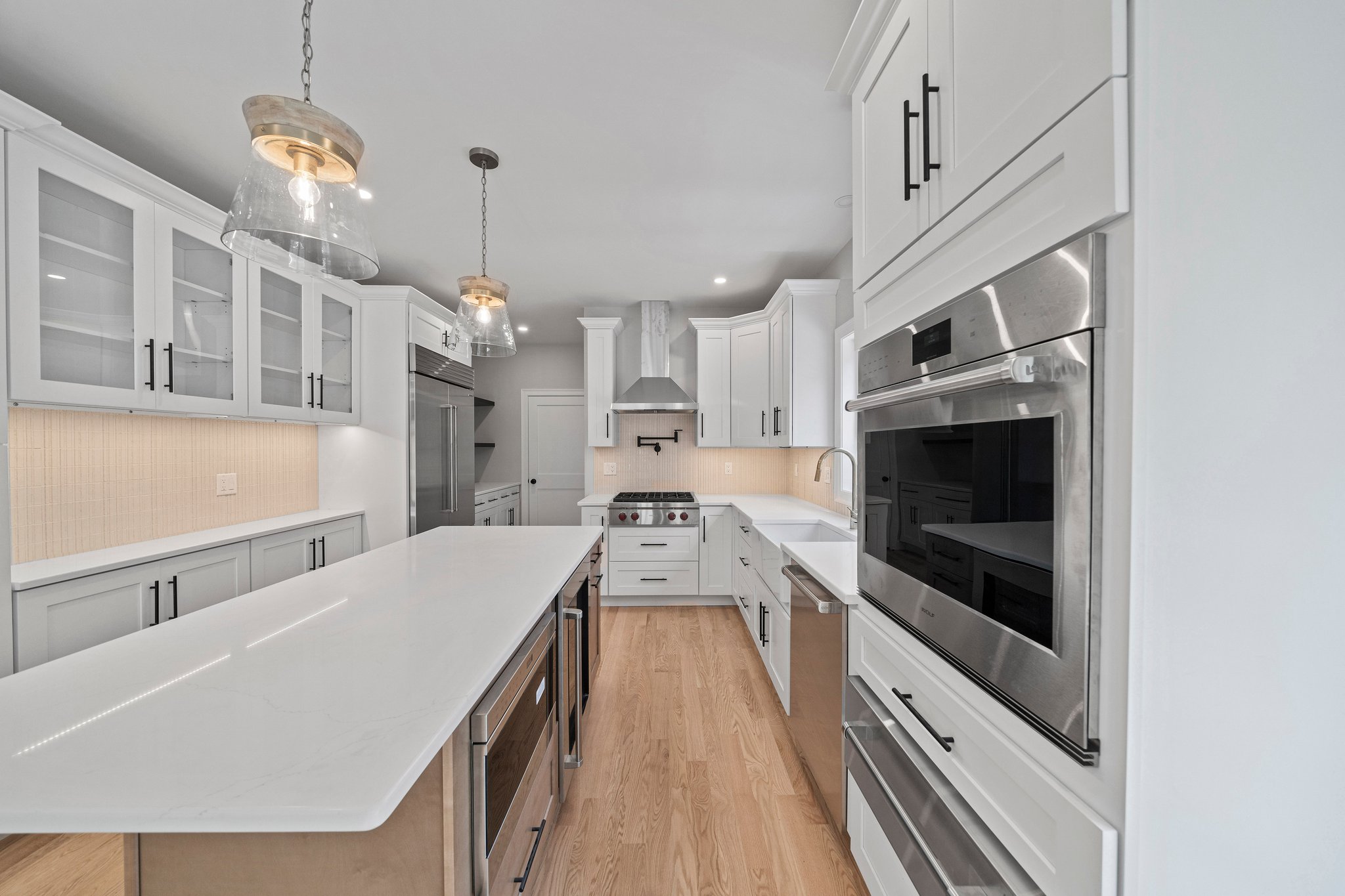 3 Everendon Road Canton, MA 02021 - Photo 4 of 35 a kitchen with stainless steel appliances granite countertop a sink dishwasher a stove and a dining table with wooden floor