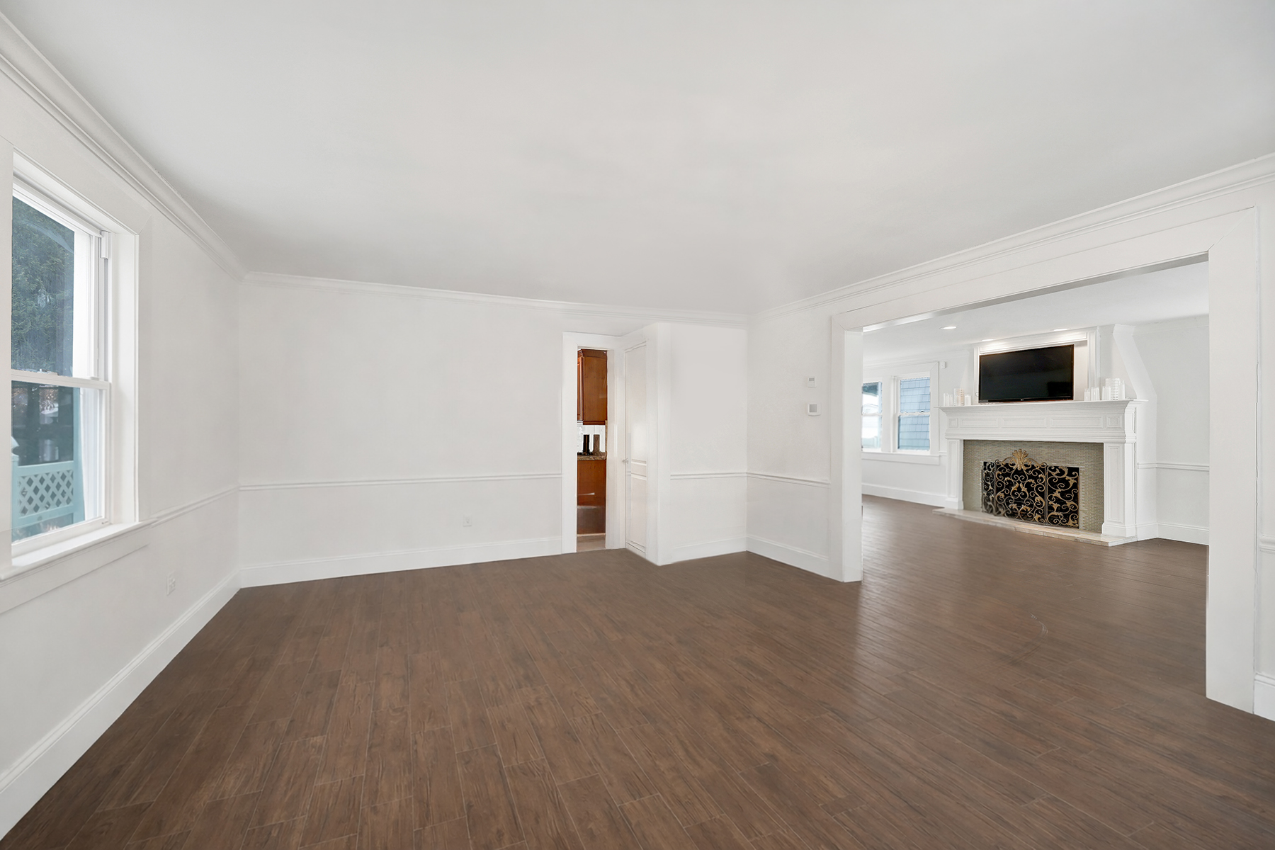 334 Beach 146th Street Queens, NY 11694 - Photo 4 of 21 a view of a livingroom with wooden floor and a fireplace