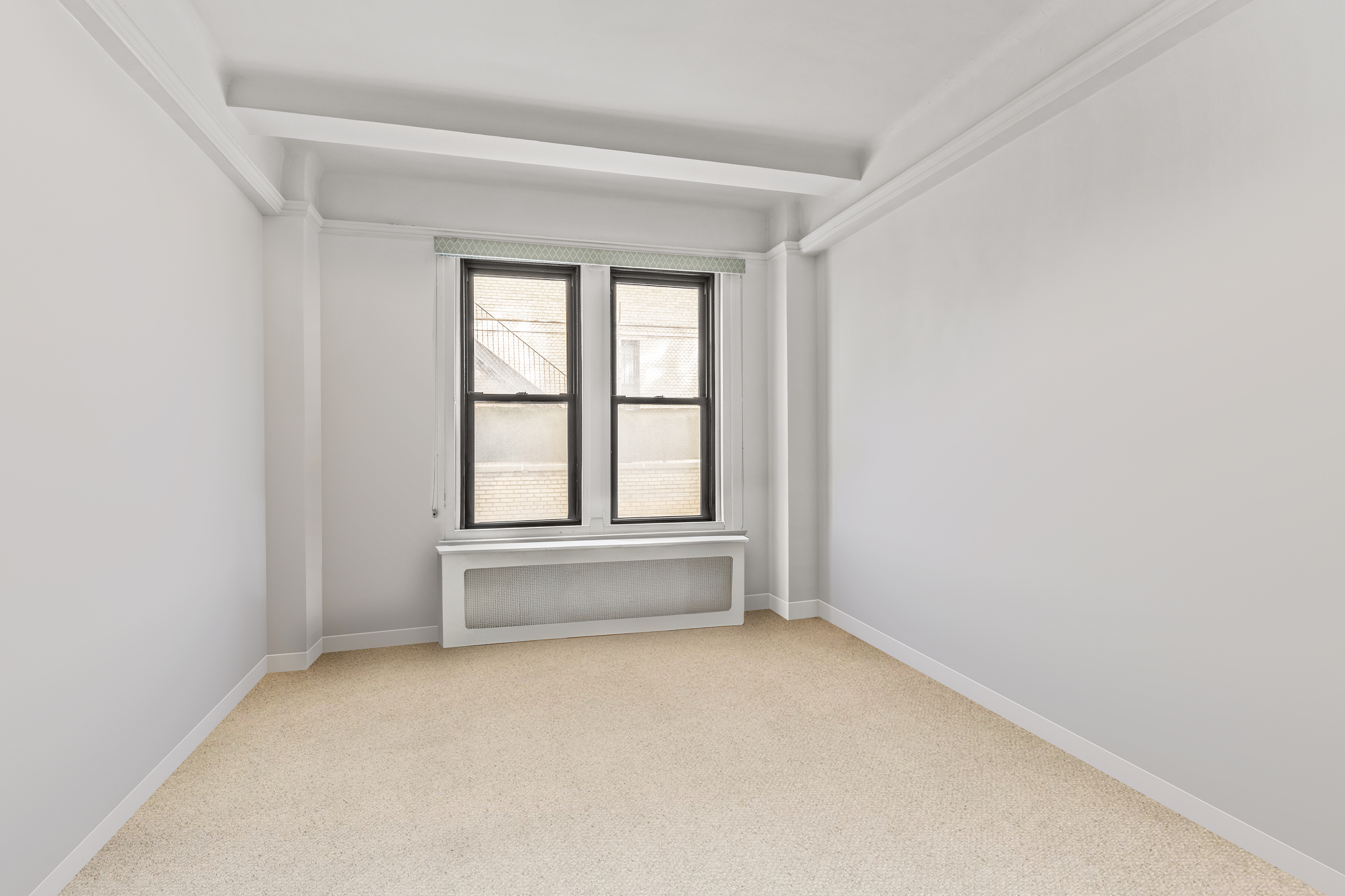 70 East 96th Street, Unit 2D Manhattan, NY 10128 - Photo 13 of 14 an empty room with a windows