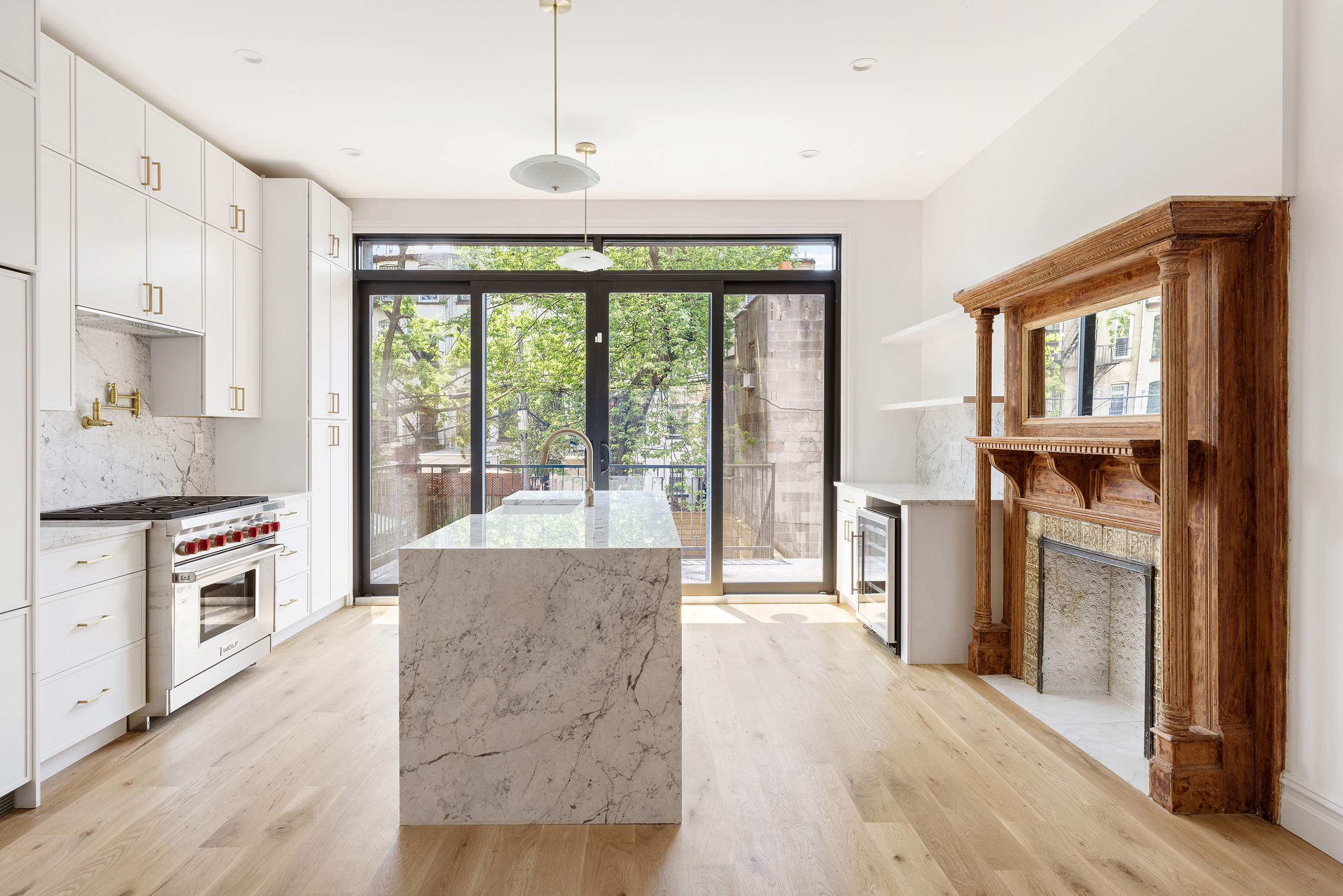 698 Macon Street Brooklyn, NY 11233 - Photo 4 of 17 a open kitchen with granite countertop a stove top oven a sink and a refrigerator