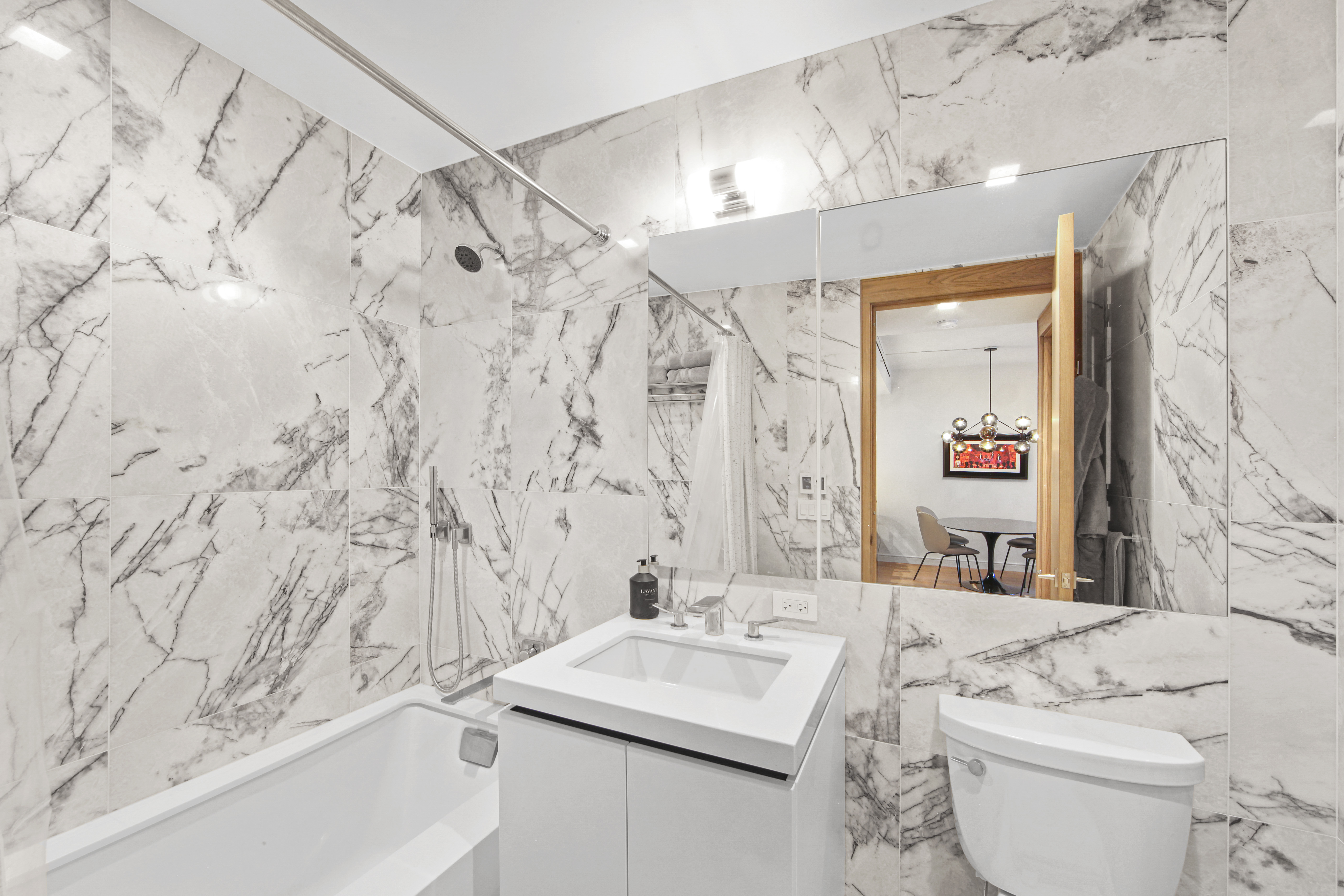 200 East 21st Street, Unit 4B Manhattan, NY 10010 - Photo 12 of 15 a bathroom with a sink toilet and shower