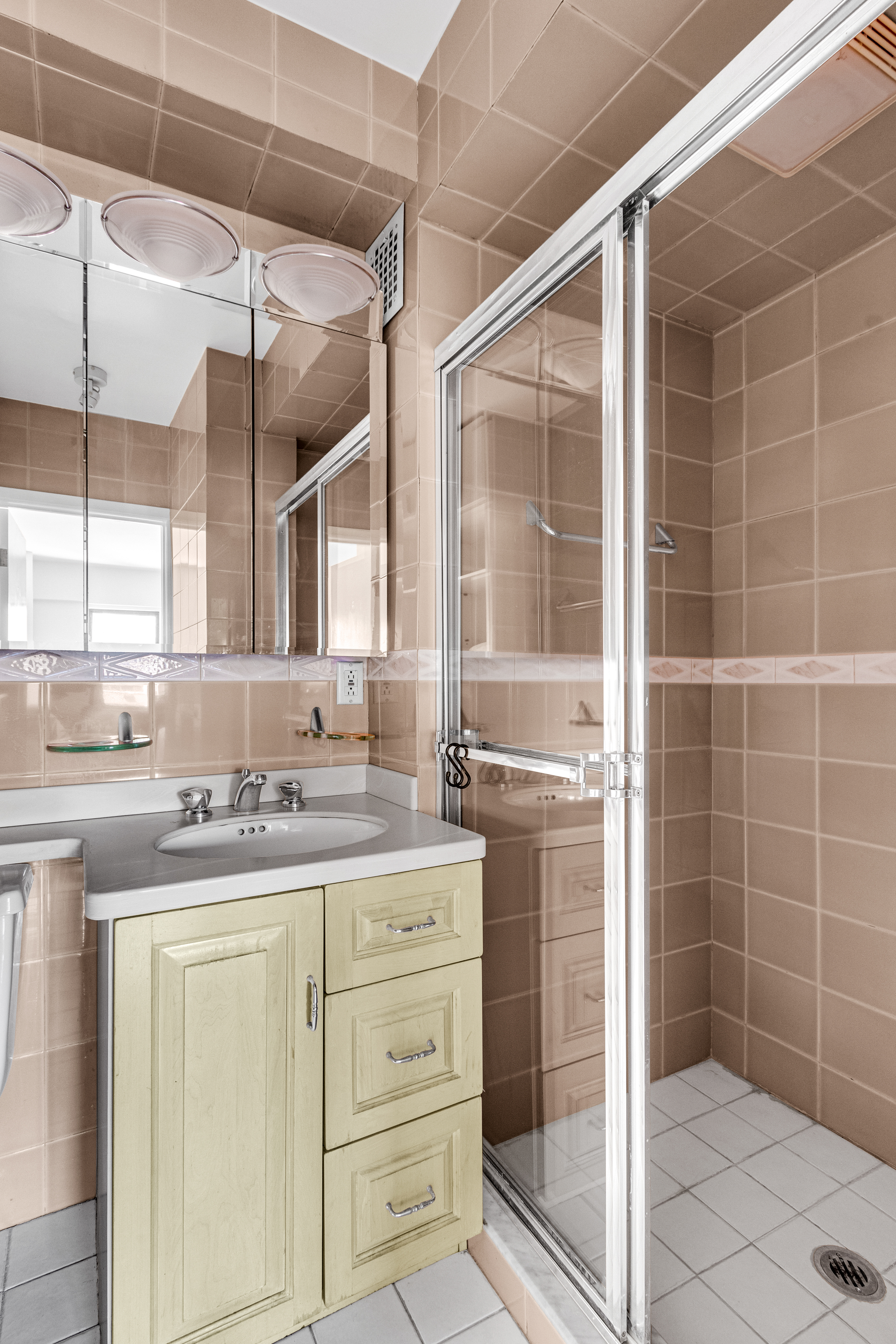 345 East 52nd Street, Unit 10CD Manhattan, NY 10022 - Photo 12 of 14 a bathroom with a shower sink and mirror