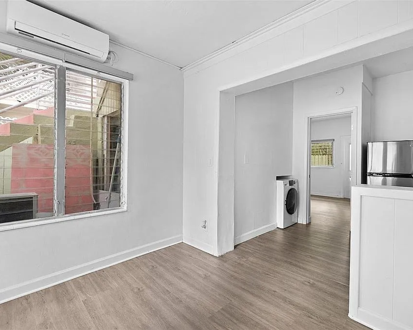 2822 Pine Tree Drive Miami Beach, FL 33140 - Photo 11 of 21 a view of a room with wooden floor and a window