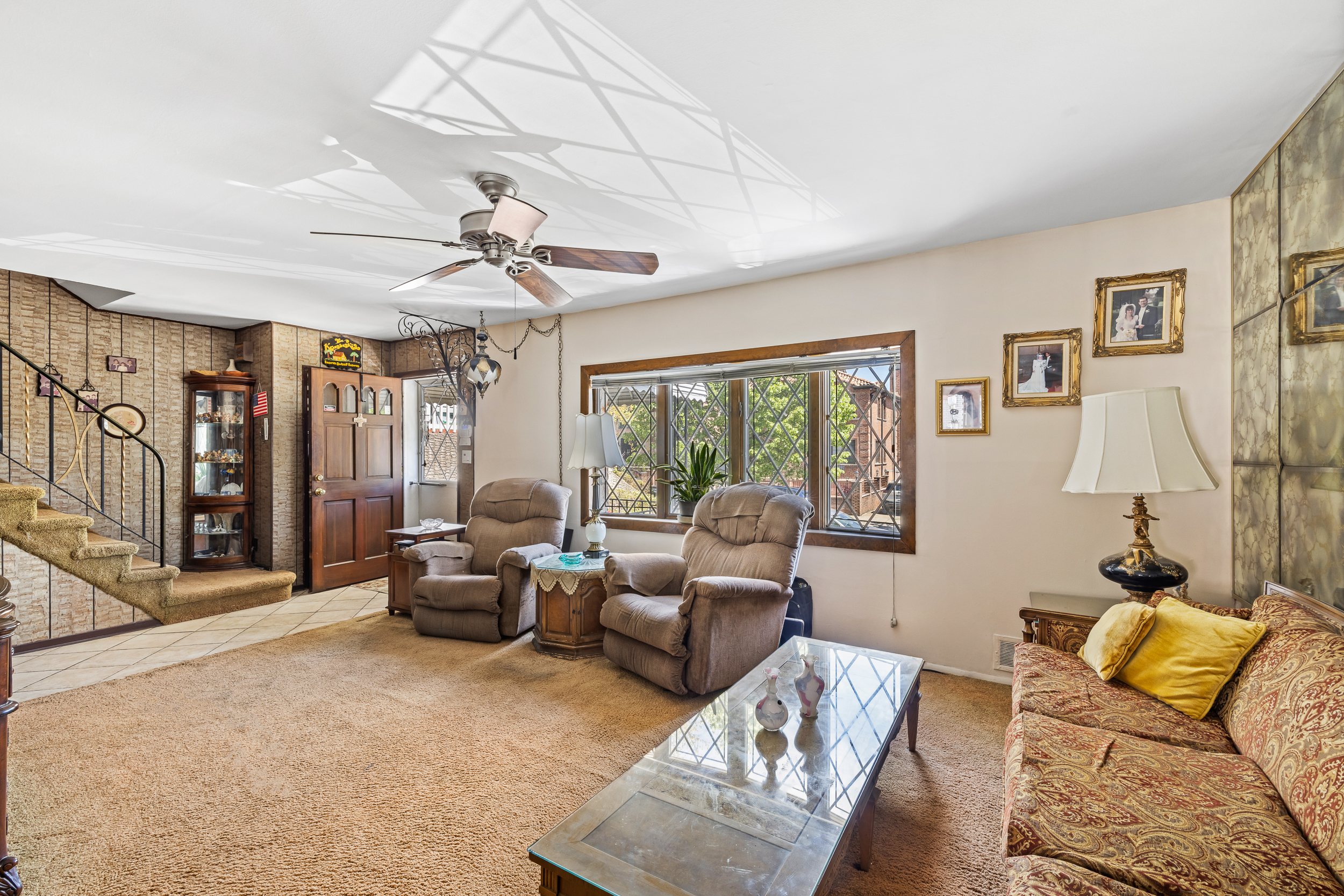 14-28 140th Street Queens, NY 11357 - Photo 4 of 14 a living room with furniture or couch and a chandelier