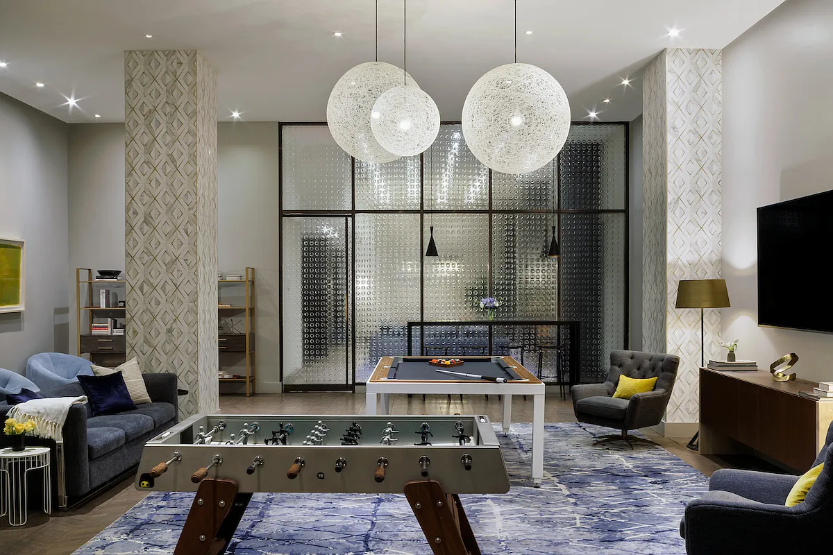 25 Broad Street, Unit 16I Manhattan, NY 10004 - Photo 20 of 23 a living room with furniture a mirror and a chandelier