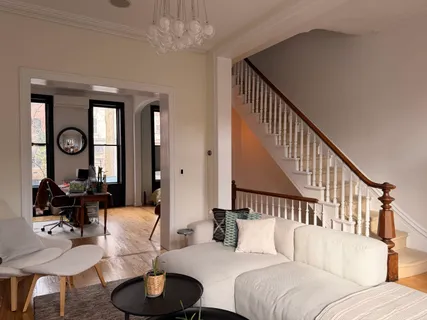 a living room with furniture chandelier and a window