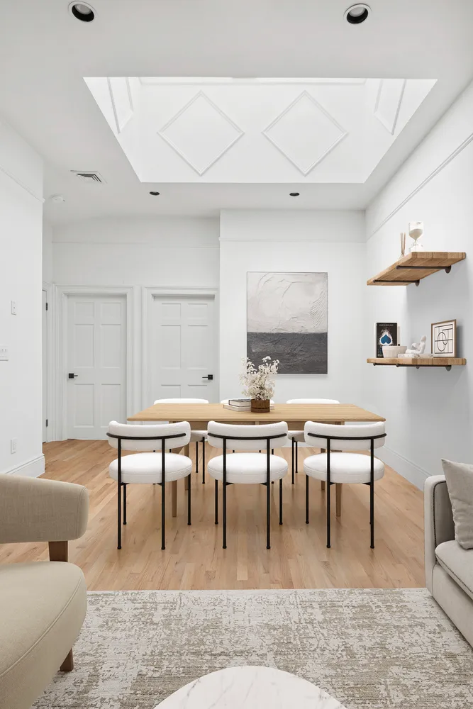 a living room with furniture a rug and a table