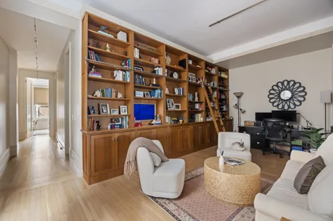 a living room with furniture and a book shelf