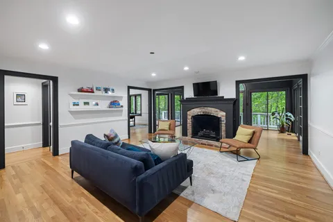 a living room with furniture and a wooden floor