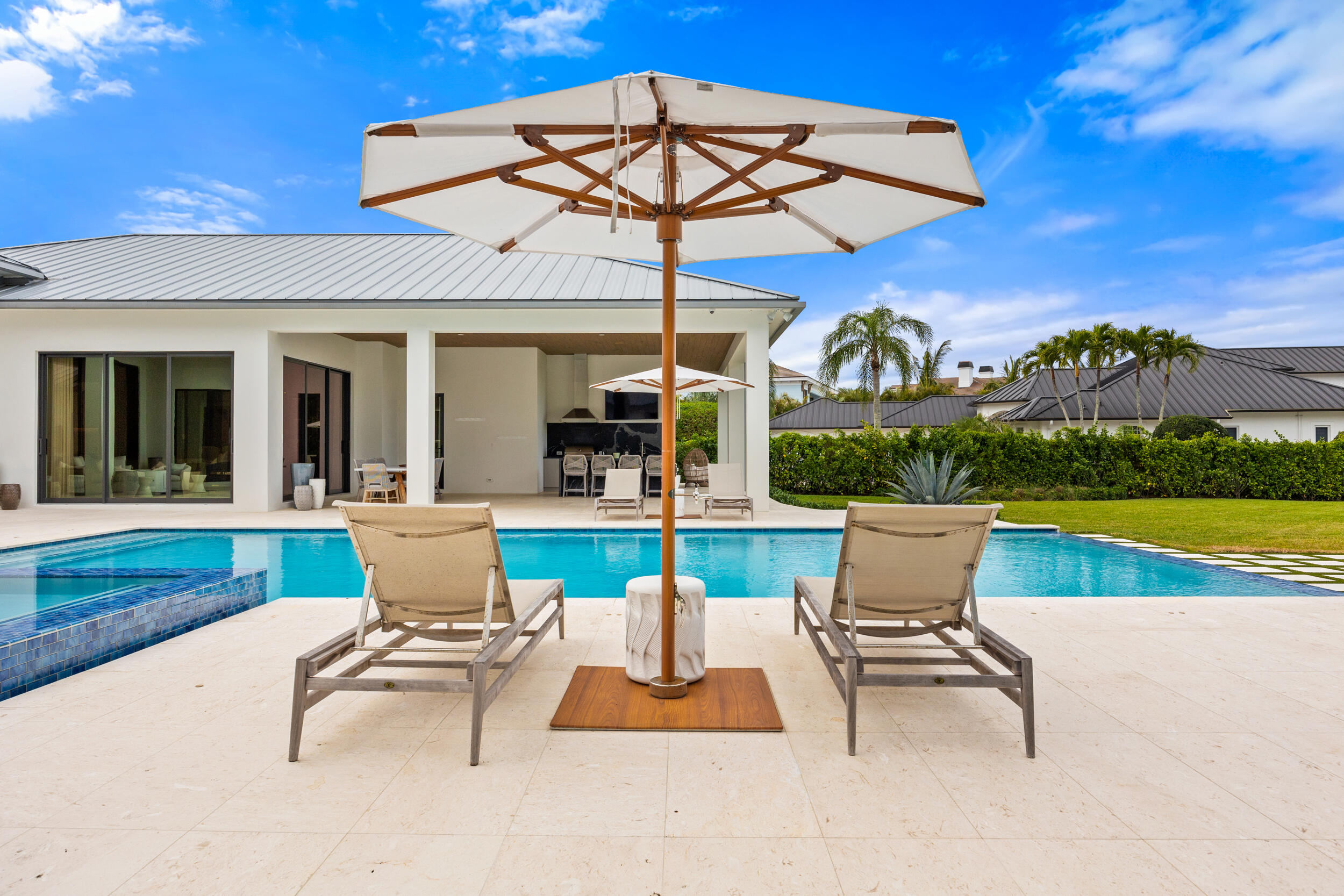 5695 Pennock Point Road Jupiter, FL 33458 - Photo 58 of 77 a view of a patio with a table chairs and a swimming pool