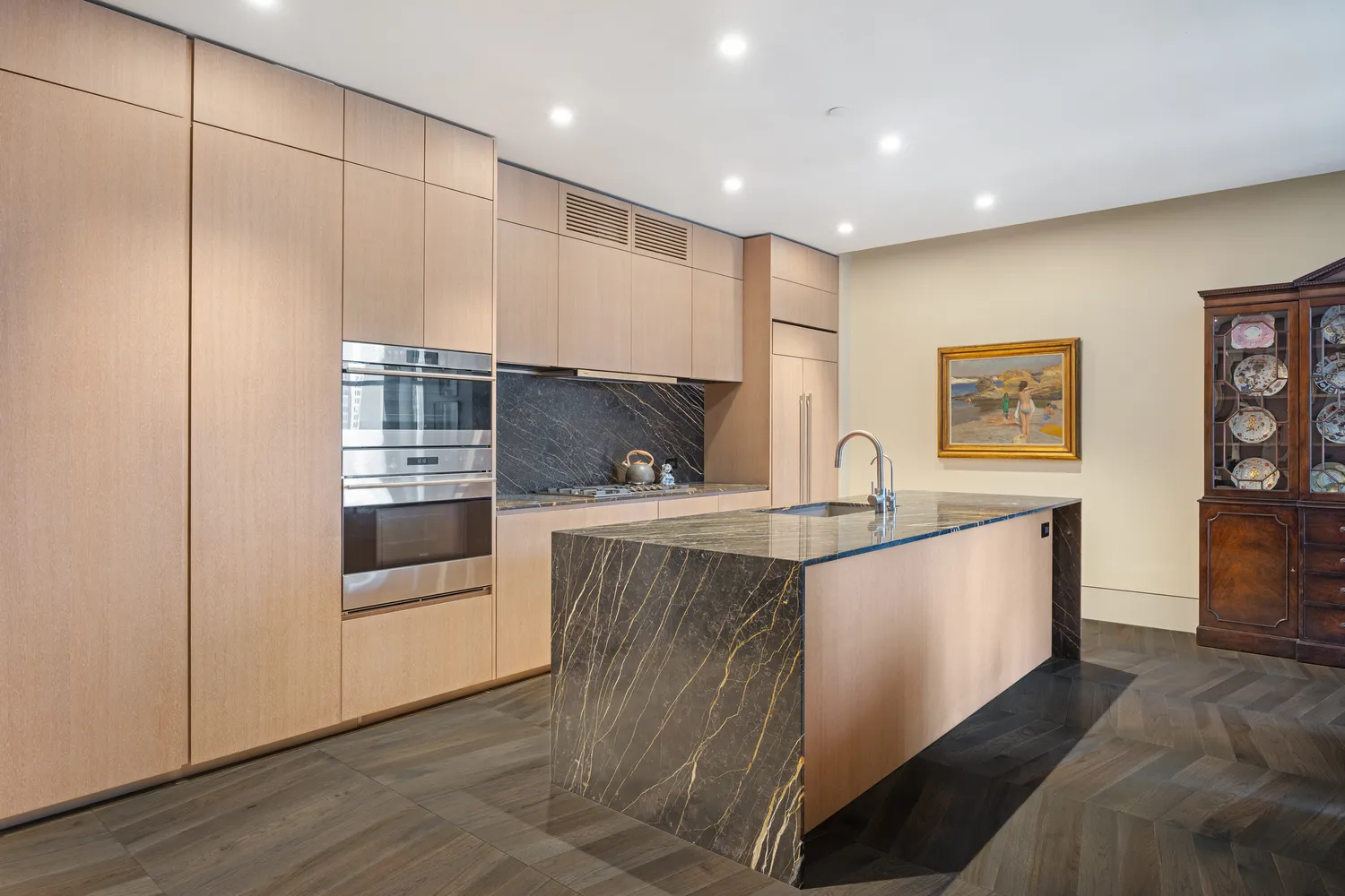 a view of kitchen with stainless steel appliances granite countertop a sink and wooden cabinets