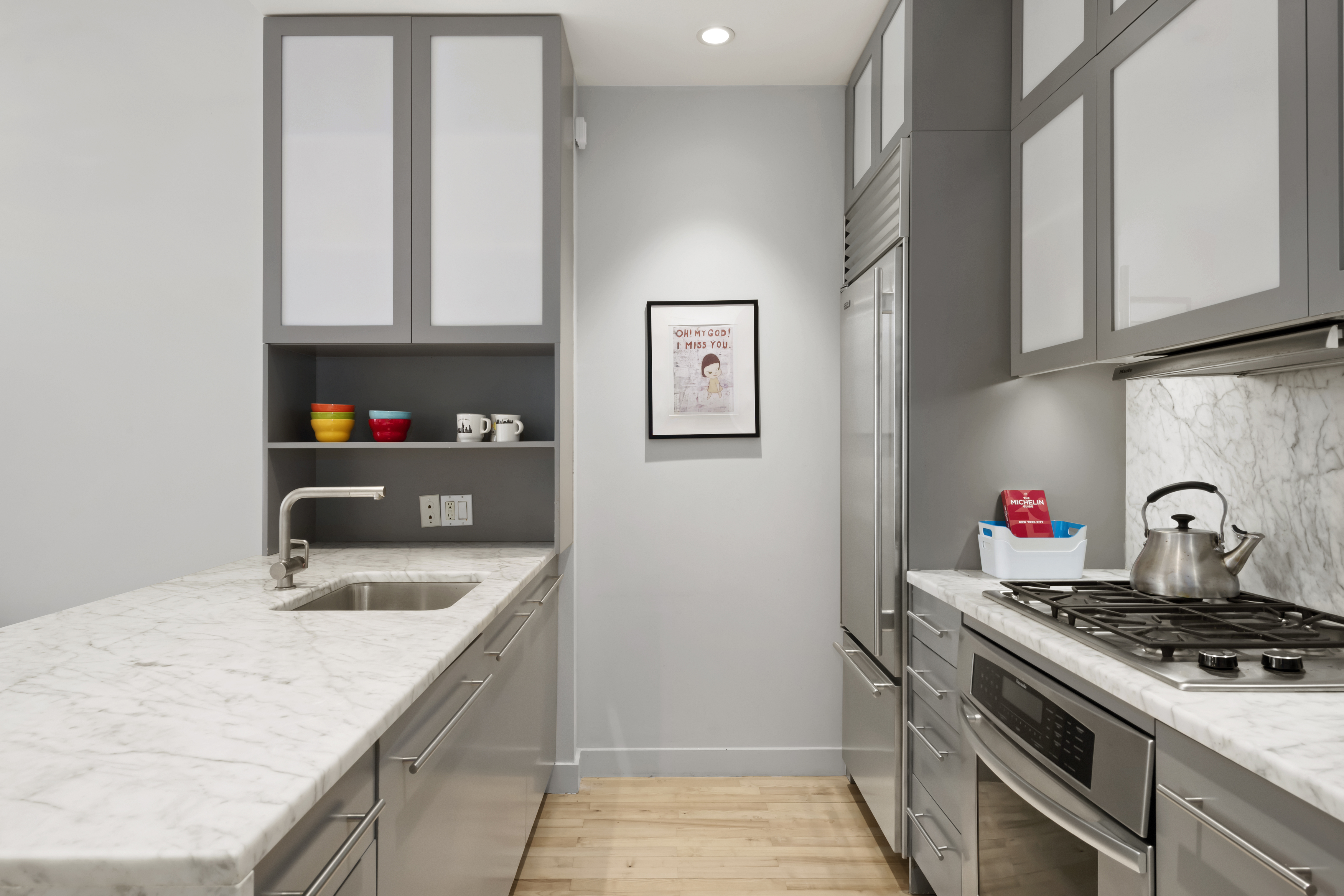 210 Lafayette Street, Unit 6D Manhattan, NY 10012 - Photo 3 of 8 a kitchen with stainless steel appliances granite countertop a sink stove and refrigerator