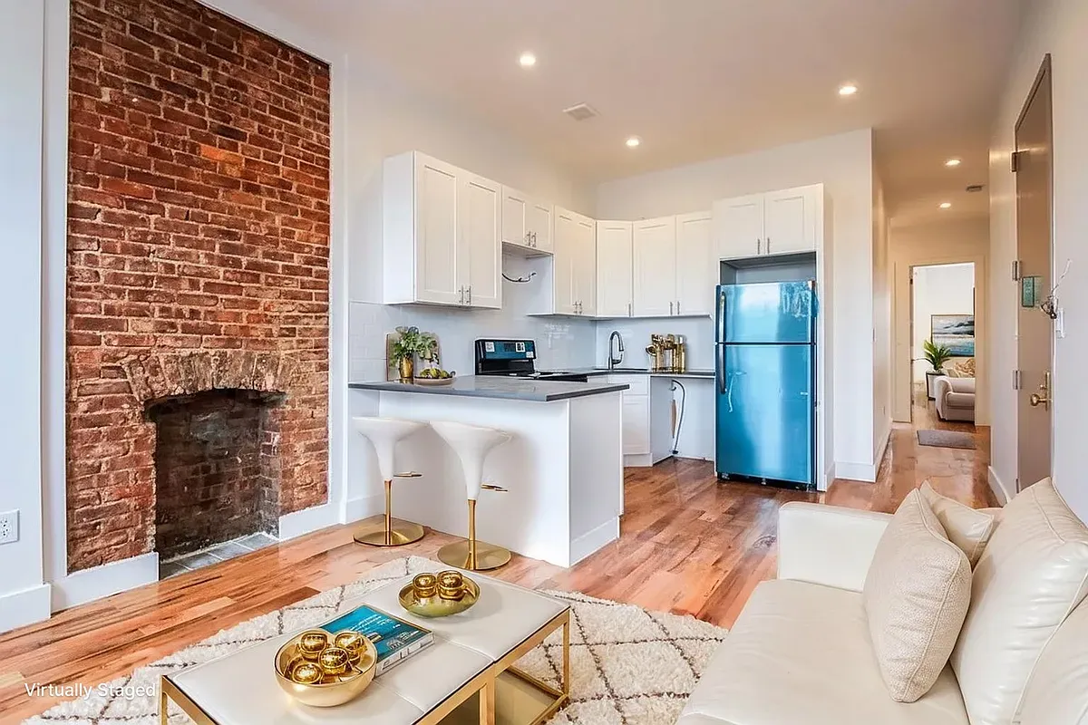 a open kitchen with white cabinets and stainless steel appliances