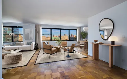 a living room with furniture and a floor to ceiling window