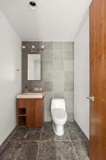a bathroom with a sink toilet a mirror and vanity