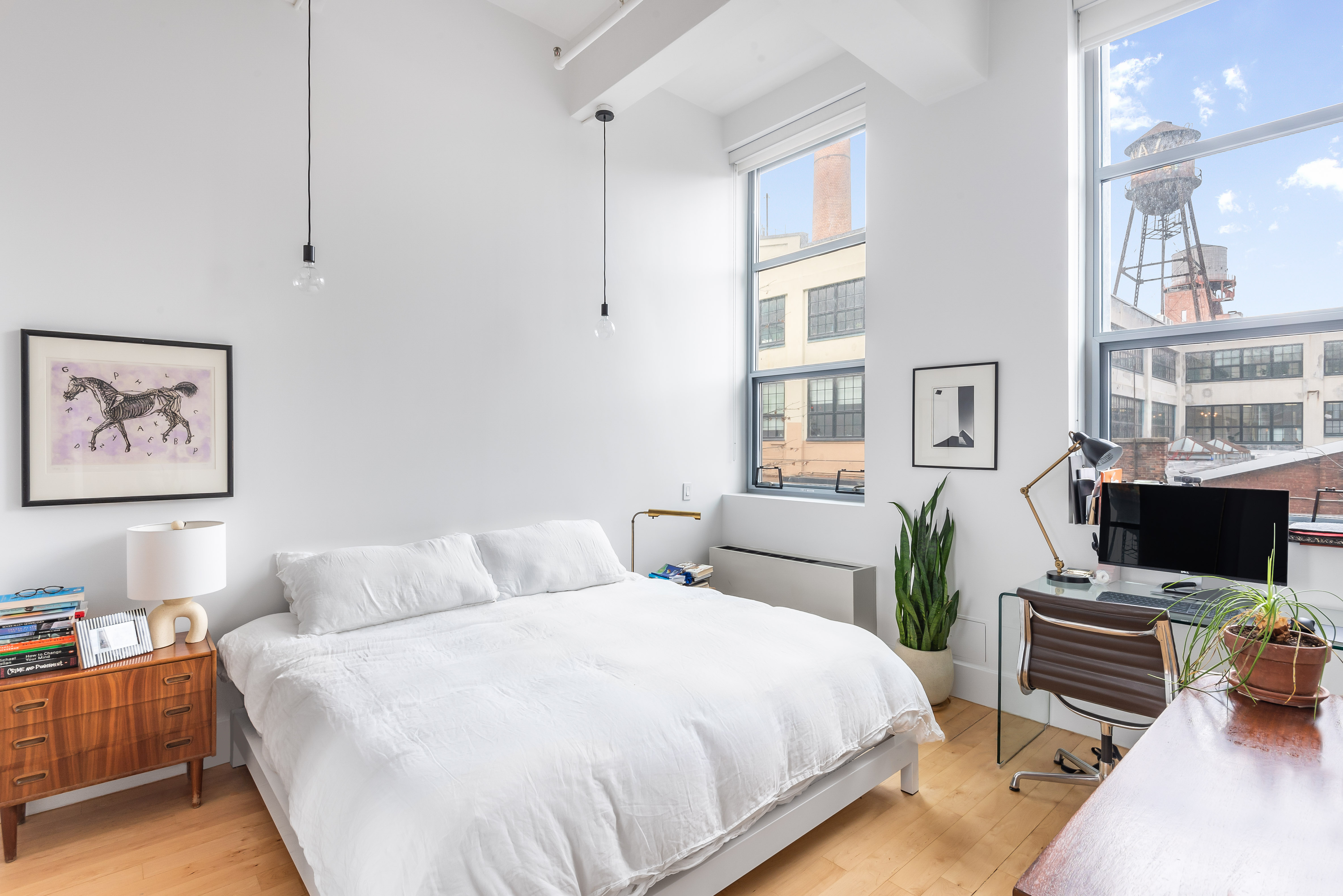 55 Berry Street, Unit 2B Brooklyn, NY 11249 - Photo 4 of 12 a bedroom with a bed a computer on the desk and a book shelf