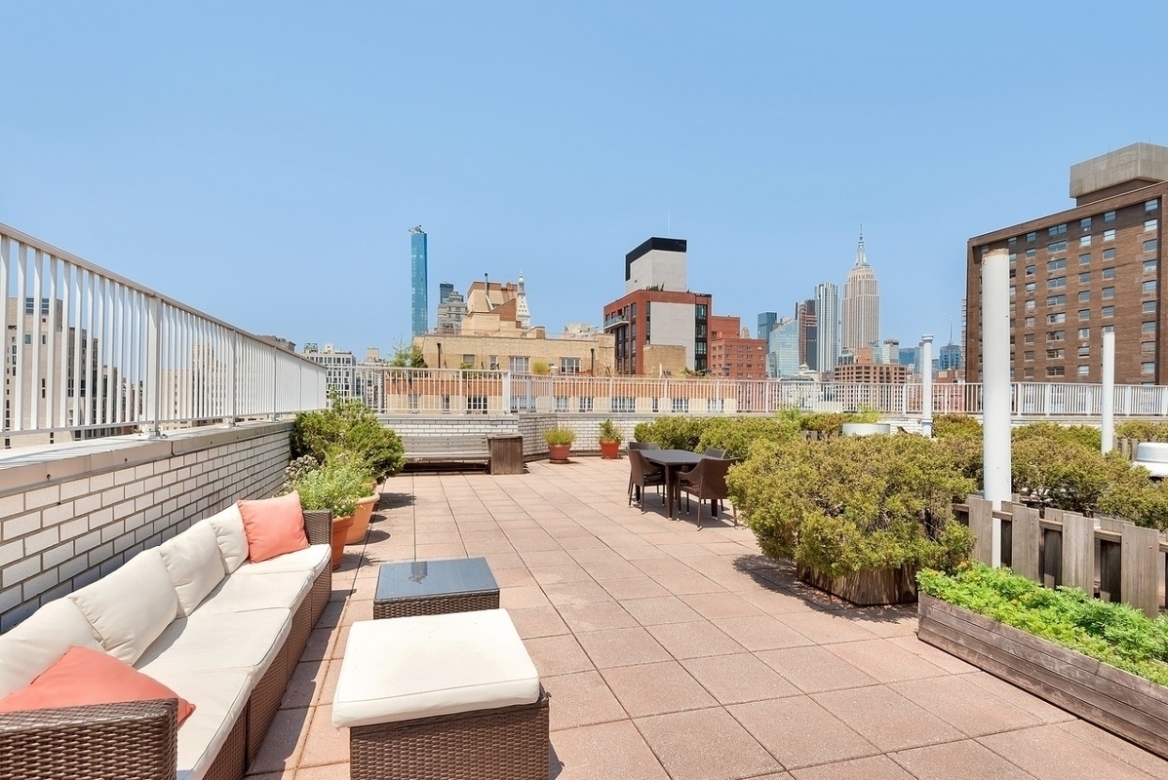 301 East 22nd Street, Unit 11U Manhattan, NY 10010 - Photo 9 of 11 a view of a patio with couches table and chairs and potted plants