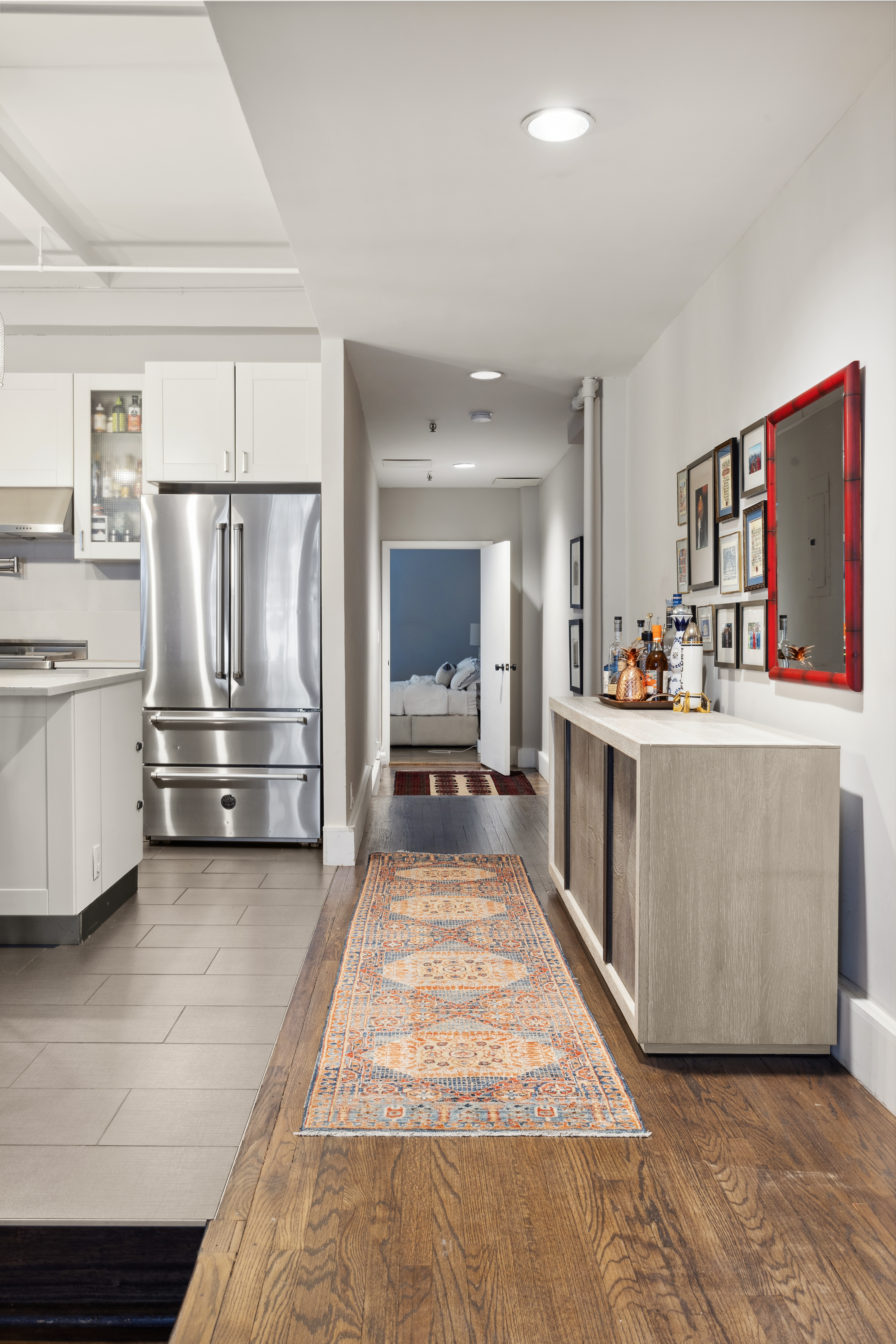 129 West 22nd Street, Unit 5A Manhattan, NY 10011 - Photo 6 of 13 a view of a kitchen with kitchen island stainless steel appliances a stove refrigerator sink and cabinets