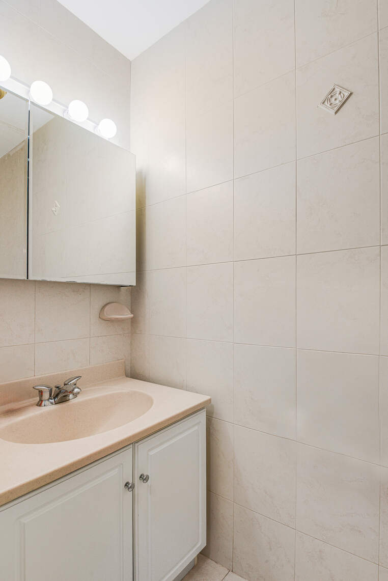 585 Warren Street, Unit 2 Brooklyn, NY 11217 - Photo 9 of 12 a bathroom with a sink and a mirror