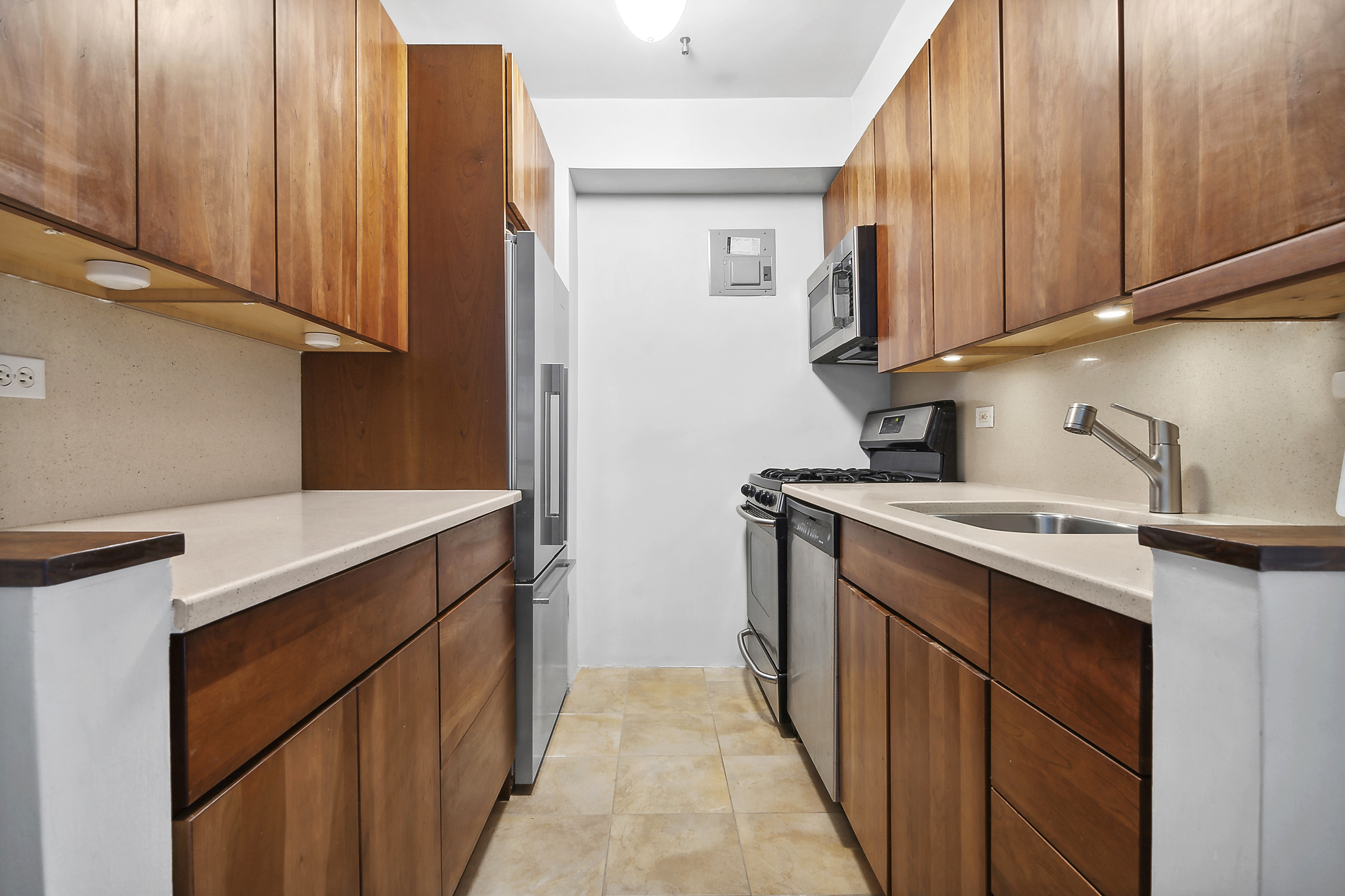 303 Beverley Road, Unit 10E Brooklyn, NY 11218 - Photo 6 of 11 a kitchen with stainless steel appliances granite countertop a sink stove and cabinets