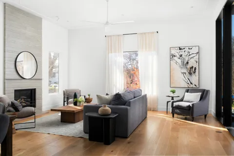 a living room with furniture and a floor to ceiling window