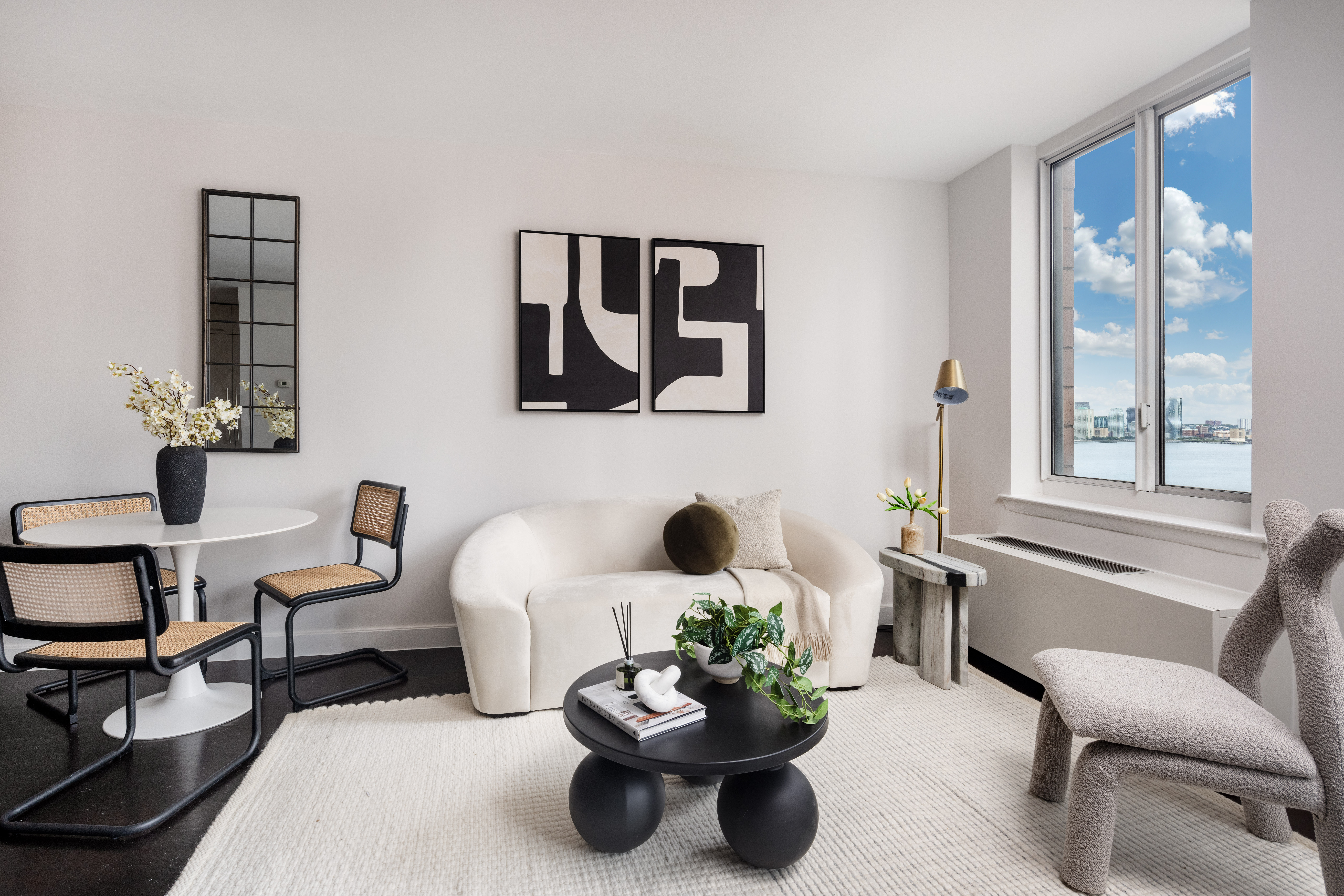 333 Rector Place, Unit 1401 Manhattan, NY 10280 - Photo 2 of 9 a living room with furniture flowerpot and window