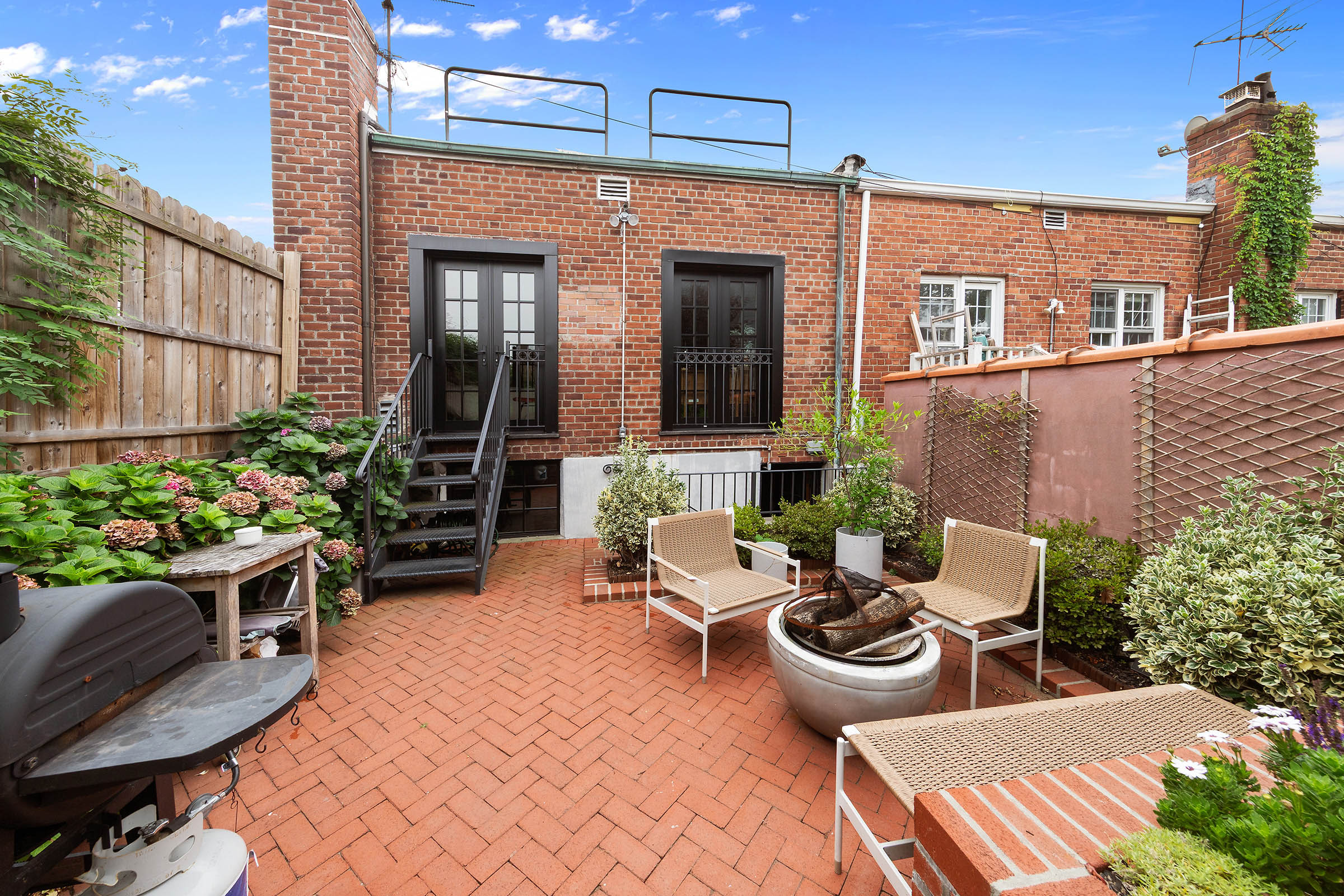 209 Onderdonk Avenue Queens, NY 11385 - Photo 14 of 16 a view of a patio with couches table and chairs and potted plants