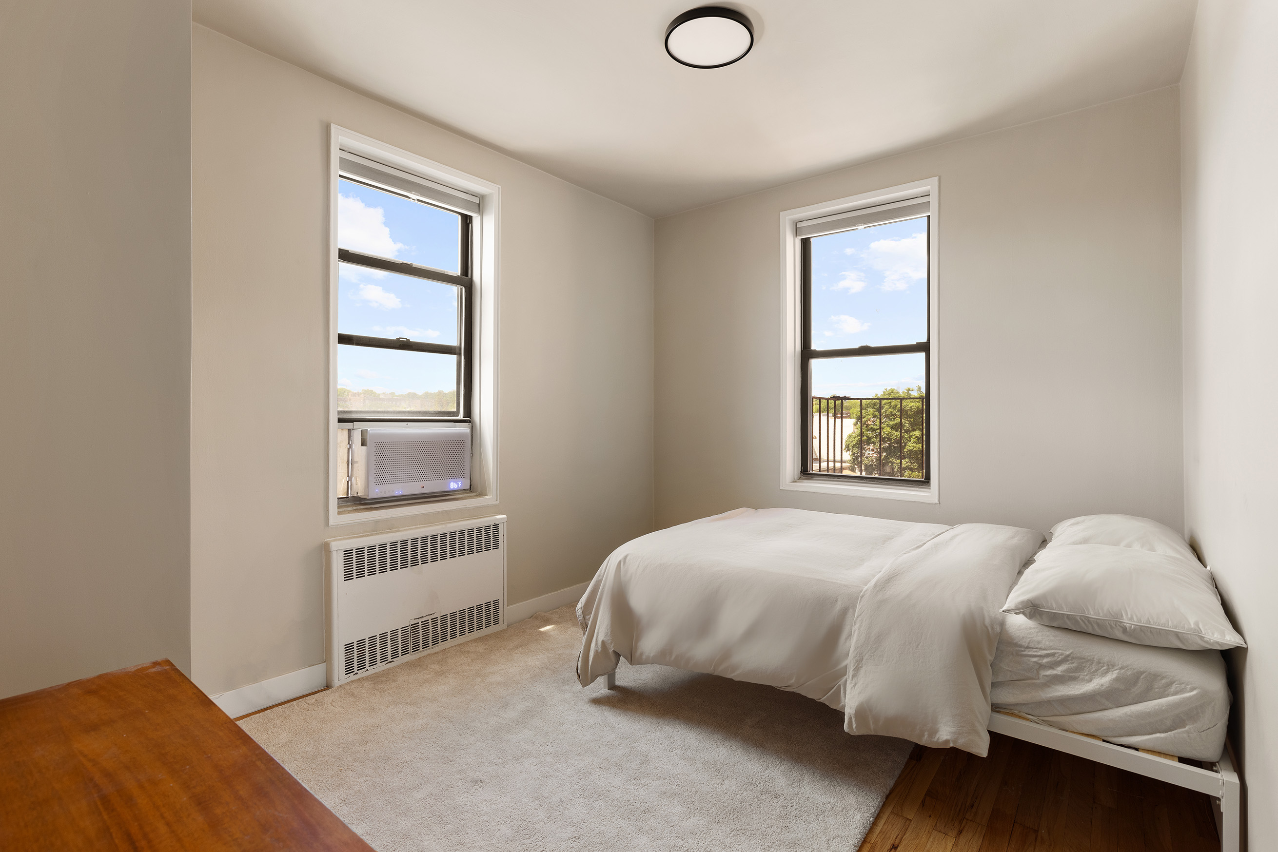 100 Ocean Parkway, Unit 4H Brooklyn, NY 11218 - Photo 9 of 11 a bedroom with a bed and a window