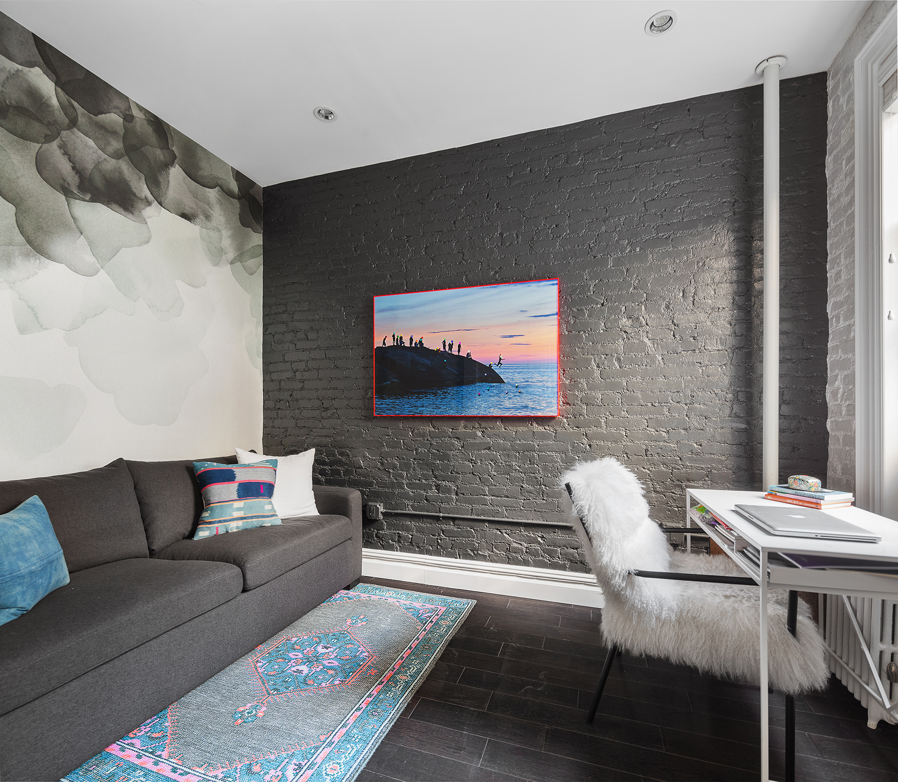 124 Thompson Street, Unit 24 Manhattan, NY 10012 - Photo 7 of 10 a living room with furniture and a flat screen tv