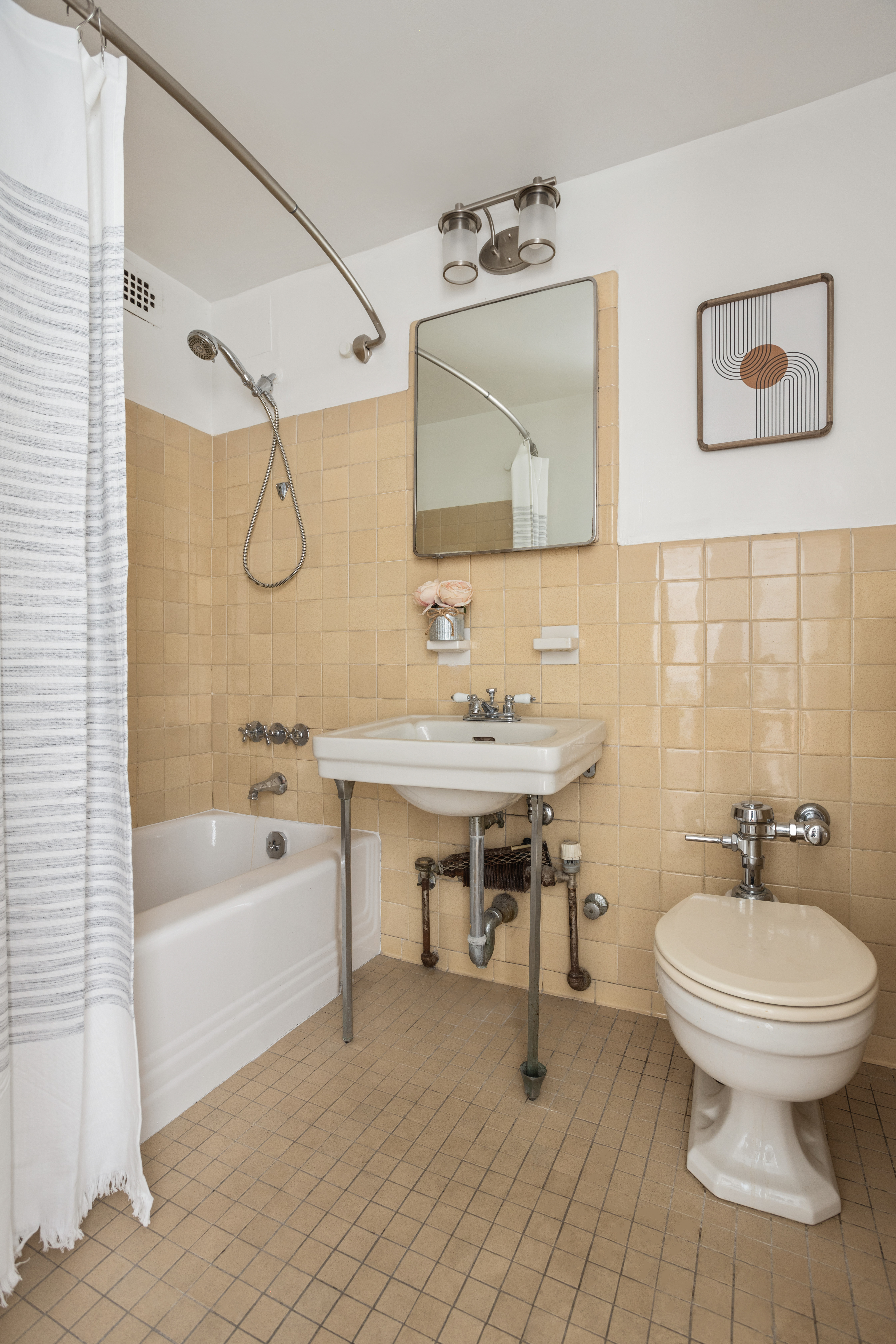 36 Sutton Place South, Unit 11D Manhattan, NY 10022 - Photo 6 of 11 a bathroom with a sink and a mirror