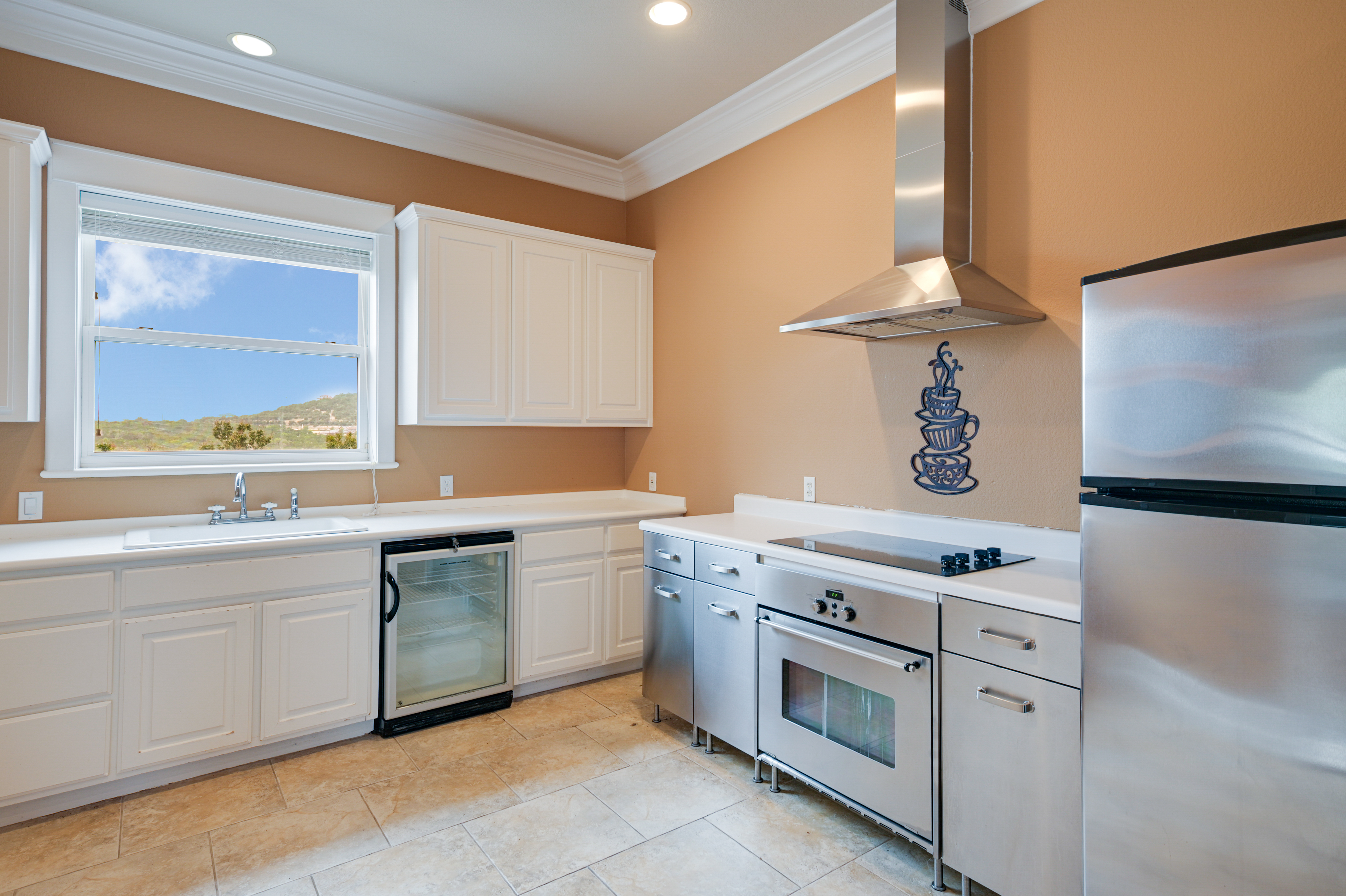 14913 Murfin Road Austin, TX 78734 - Photo 27 of 40 a kitchen with stainless steel appliances granite countertop a stove a sink and a microwave