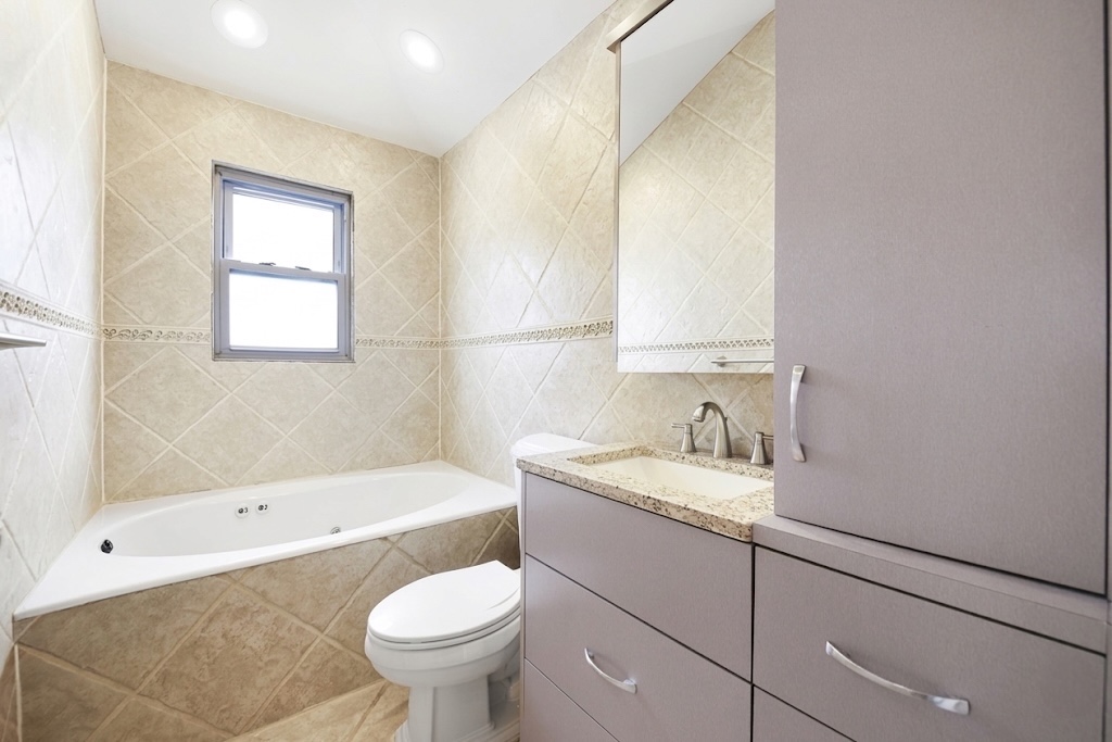 2310 East 66th Street Brooklyn, NY 11234 - Photo 19 of 24 a bathroom with a sink toilet and bathtub