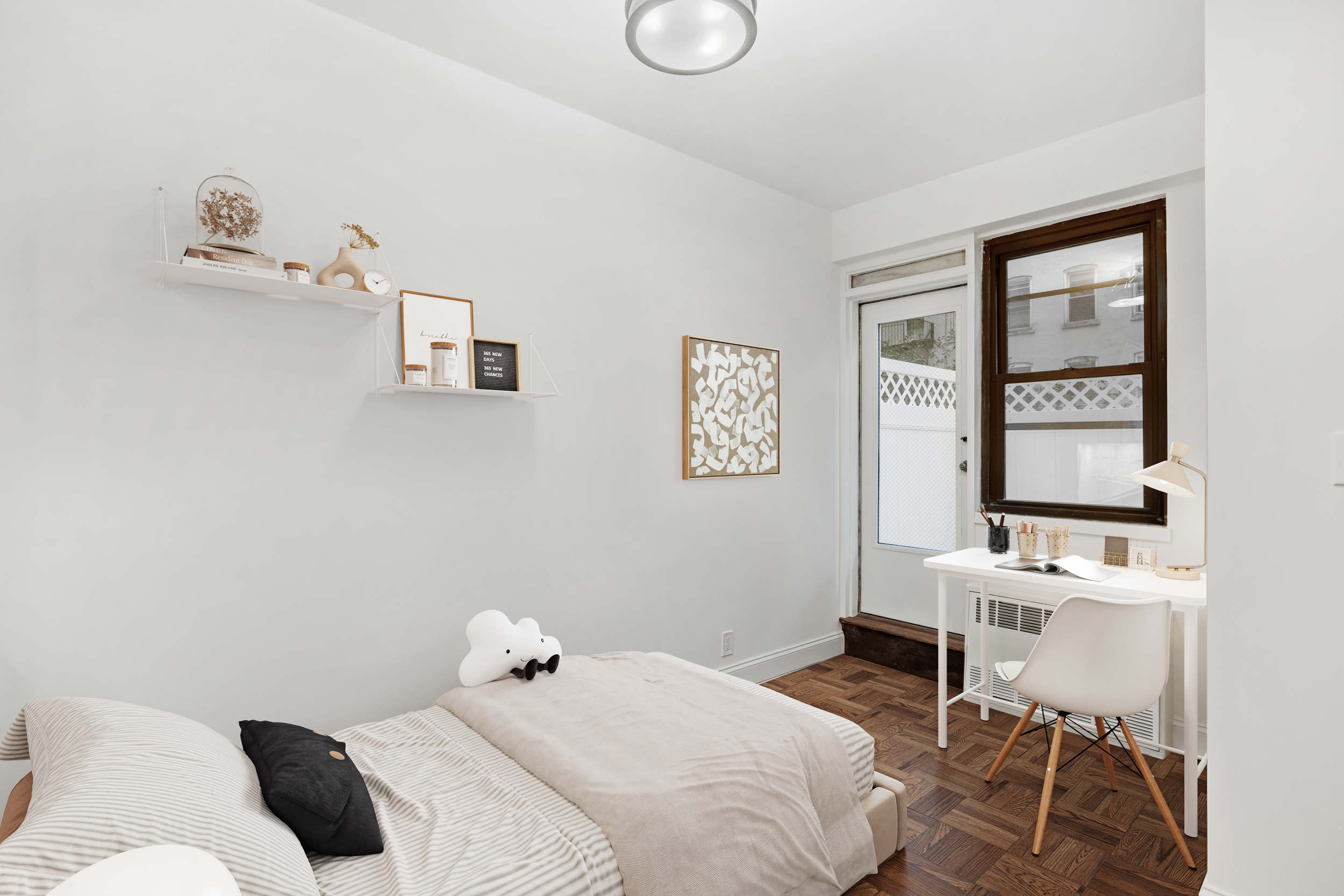 315 East 65th Street, Unit 1A Manhattan, NY 10065 - Photo 3 of 12 a bedroom with a bed and a window