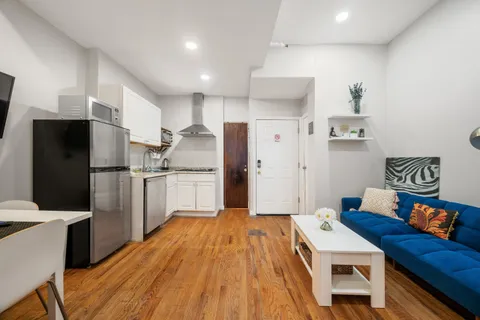 a kitchen with stainless steel appliances a refrigerator and a stove top oven