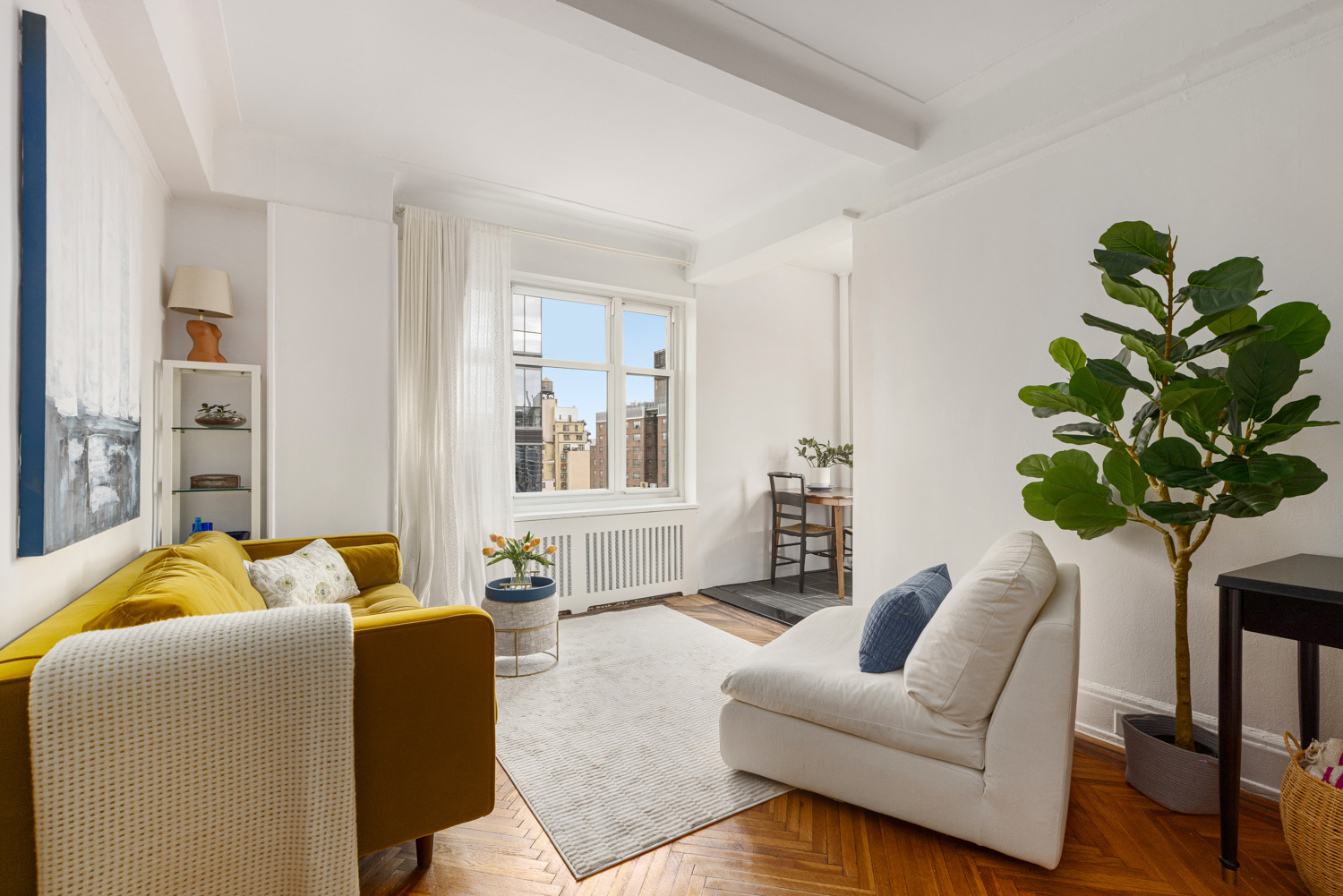 233 West 99th Street, Unit 19A Manhattan, NY 10025 - Photo 3 of 10 a living room with furniture flowers and a potted plant