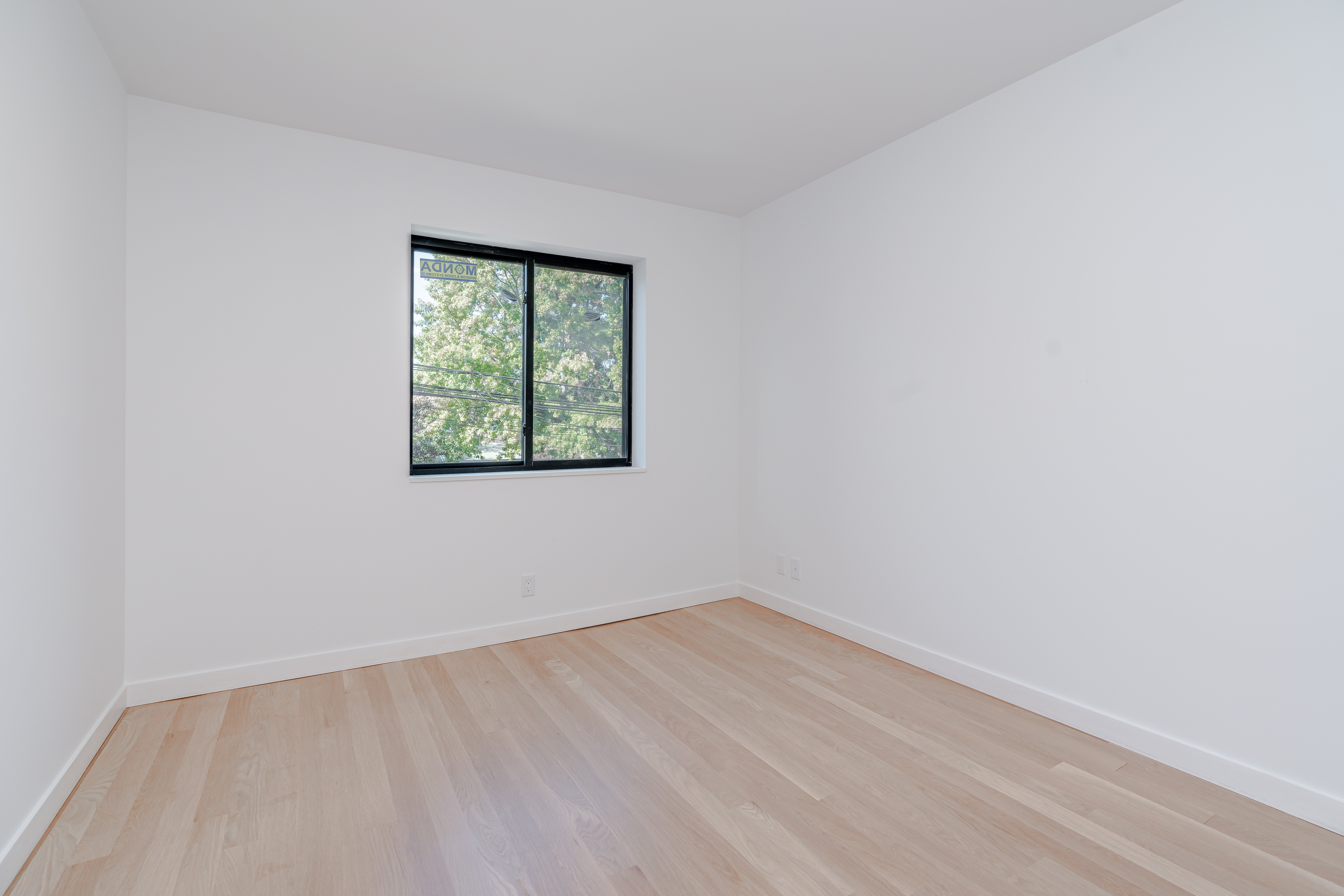 20-15 46th Street, Unit 2 Queens, NY 11105 - Photo 11 of 16 an empty room with a window