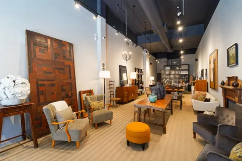 a living room with lots of furniture and gym equipment